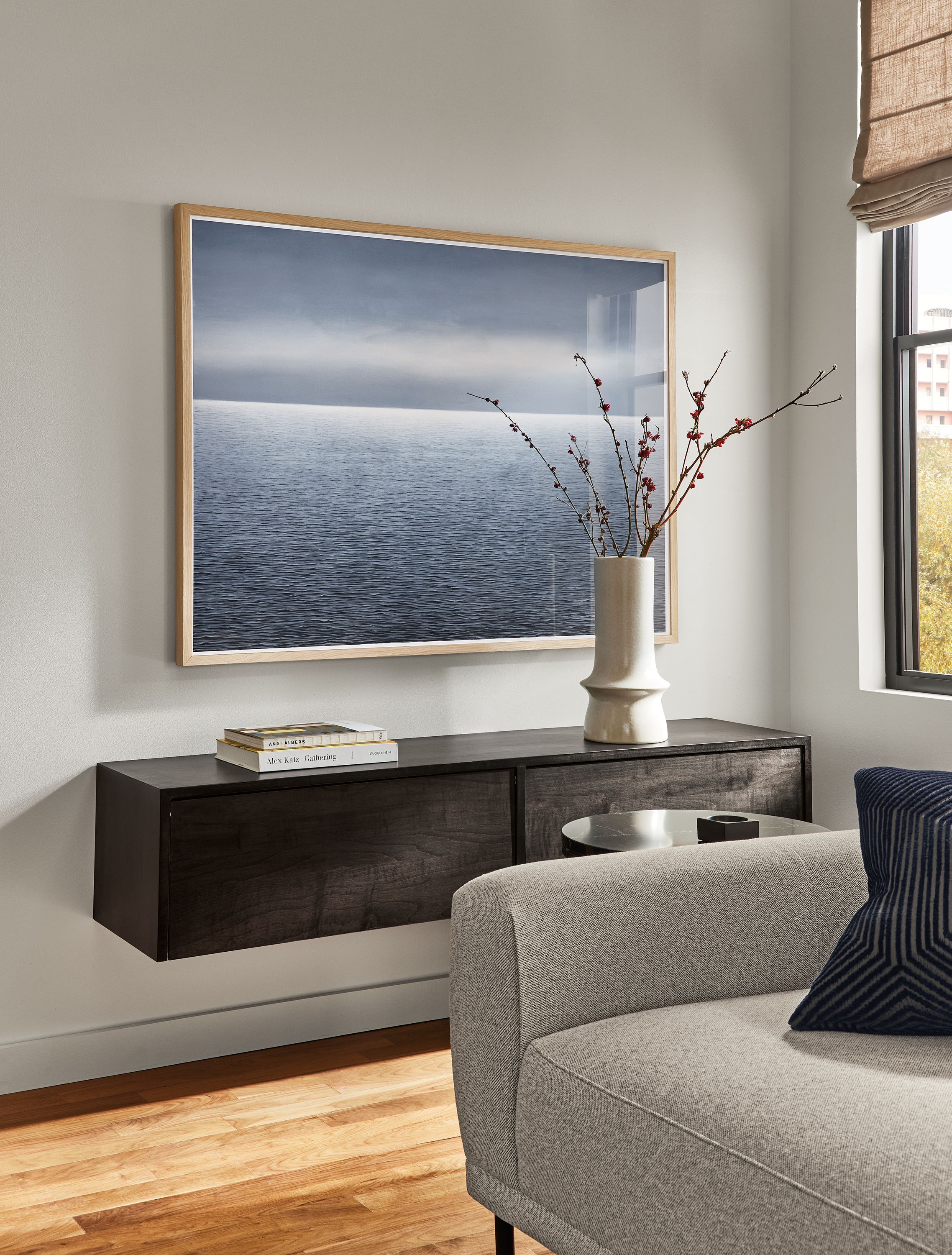 Detail of Adin Murray wall art titled, North Atlantic 1 on a wall above a Hover 60-wide wall-mounted cabinet in charcoal.