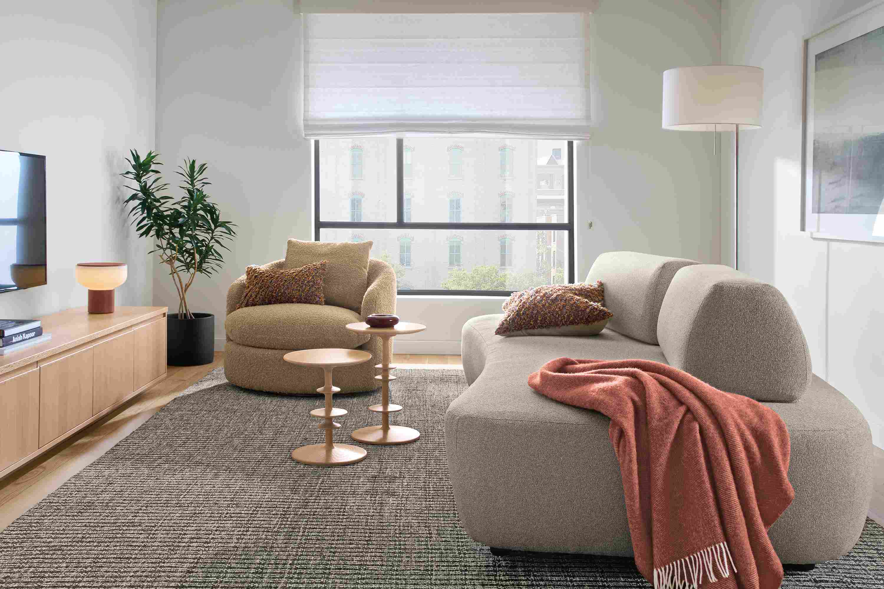 Living room with Muse 101-wide daybed in Tatum Bone, Suri swivel chair in Dornick Camel and 2 parks end tables in salt on red oak.