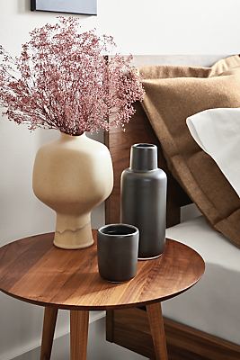 Room setting with a Rae 18-round end table in Walnut with Nadia carafe and tumbler.