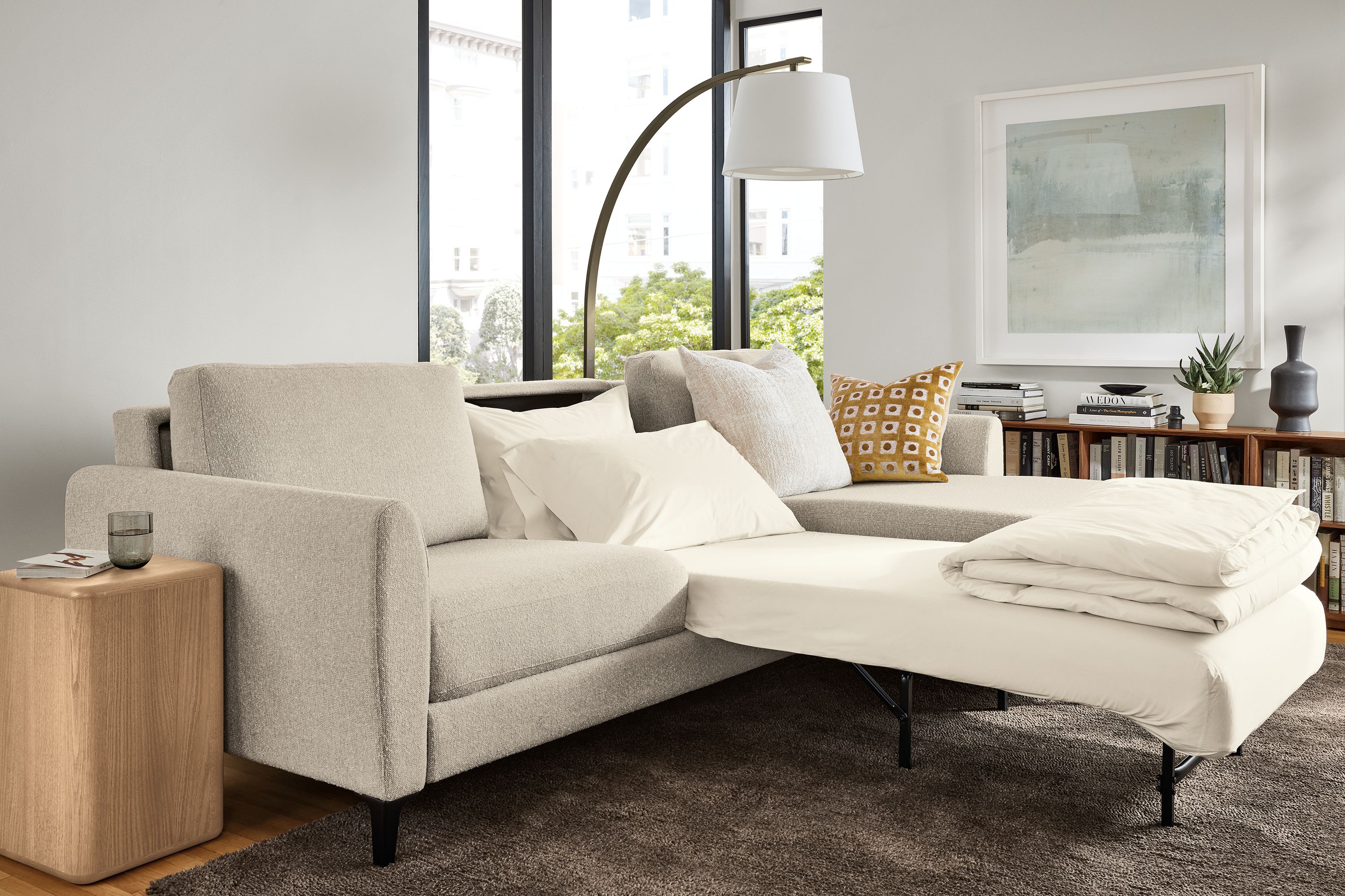 Living room with Natalia queen sleeper sofa in conley natural shown with one bed extended.