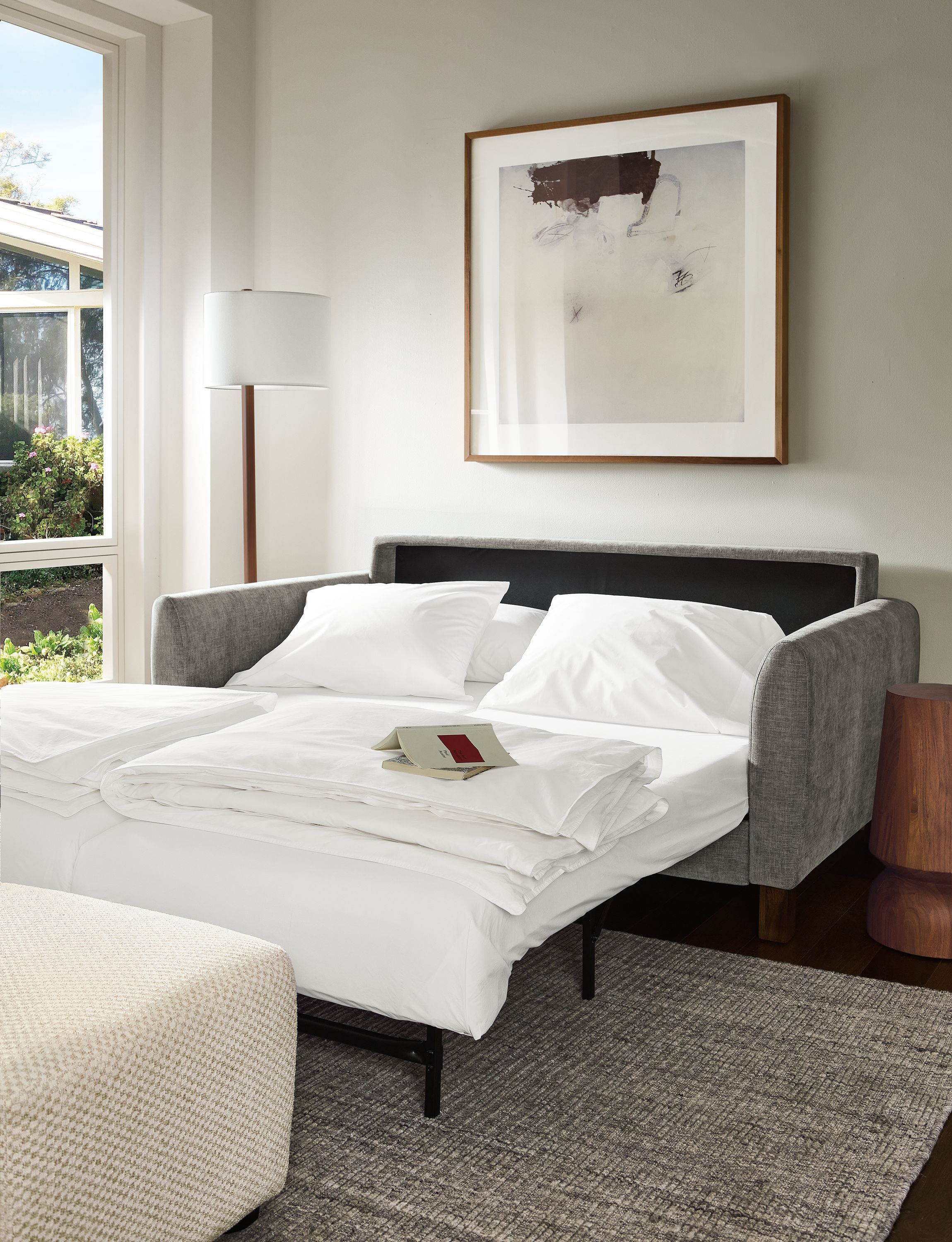 Living room with Natalia 72-wide queen sleeper sofa with Mori Graphite shown with bed open and extended.