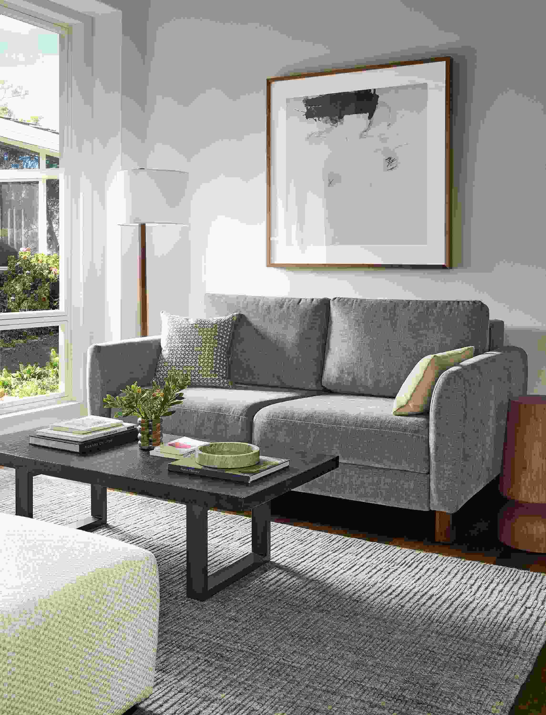 Living room with Natalia 72-wide queen sleeper sofa in Mori Graphite and Artis 6 by 9 rug in grey.