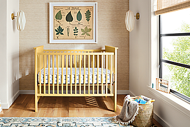 Bedroom setting with a Nest Crib Bed, Hudson Six-Drawer Chest and an Ona rug.
