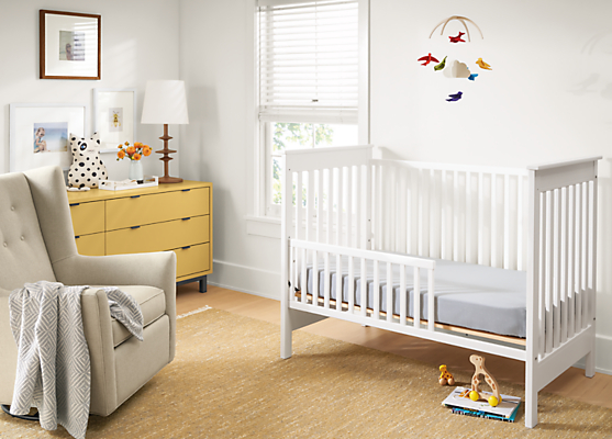 Detail of Nest crib in White in baby's room.