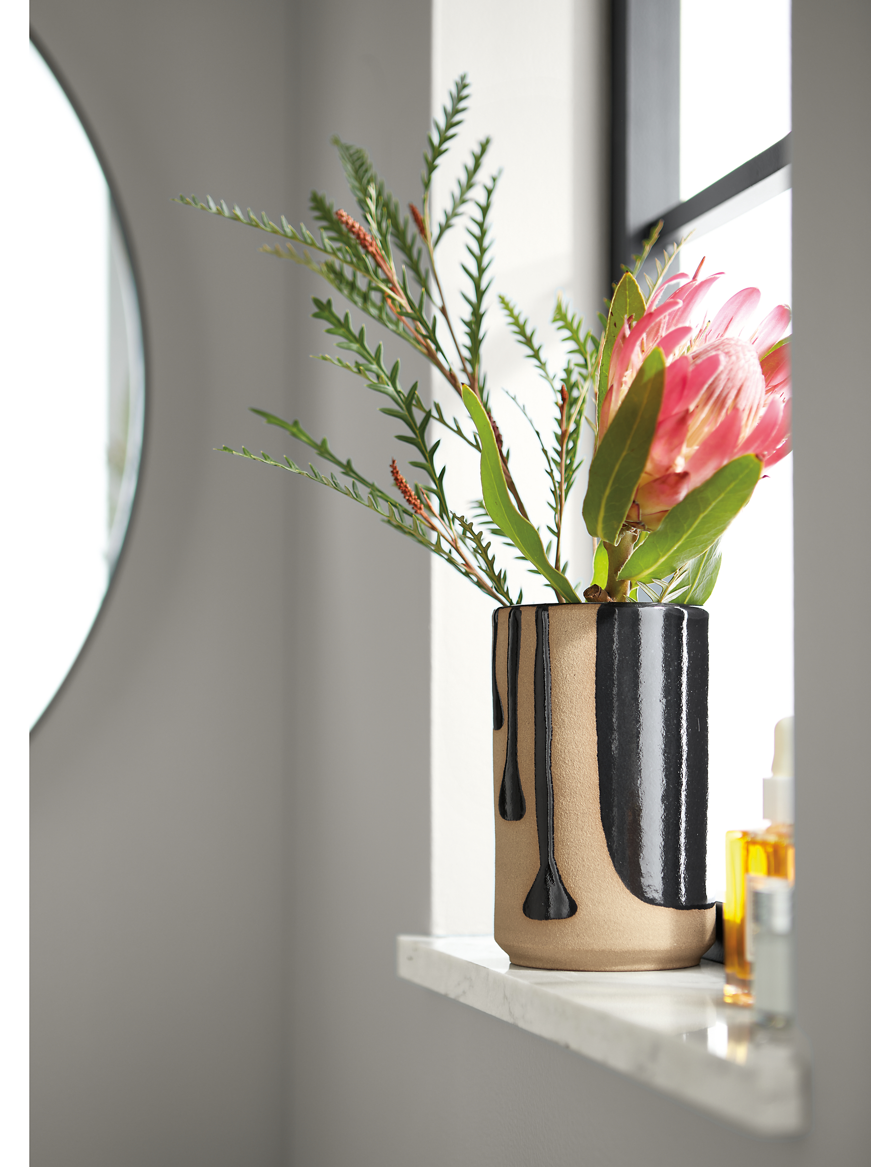 Room setting of a Niels Small Vase on a window sill.