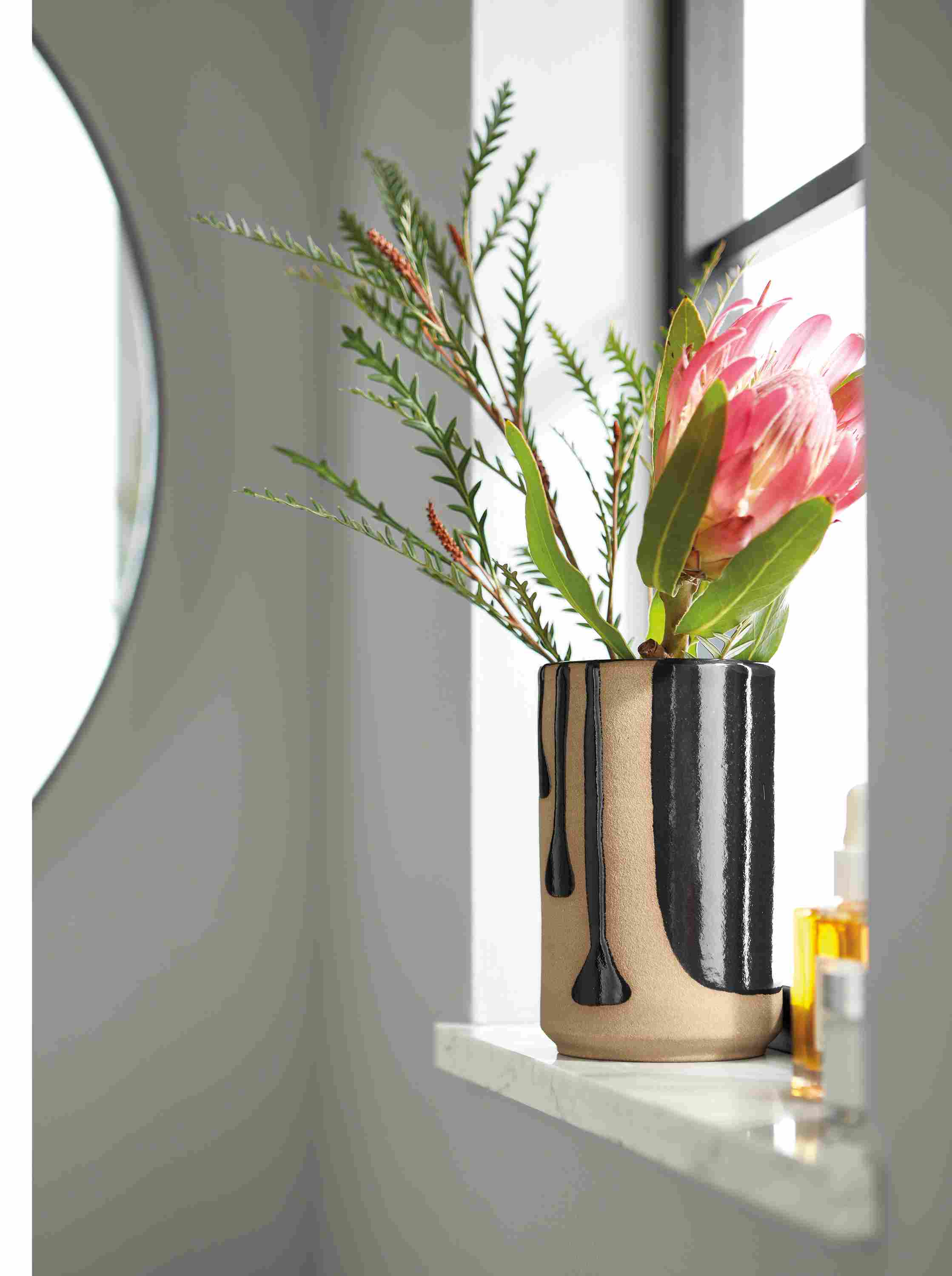 Room setting of a Niels Small Vase on a window sill.