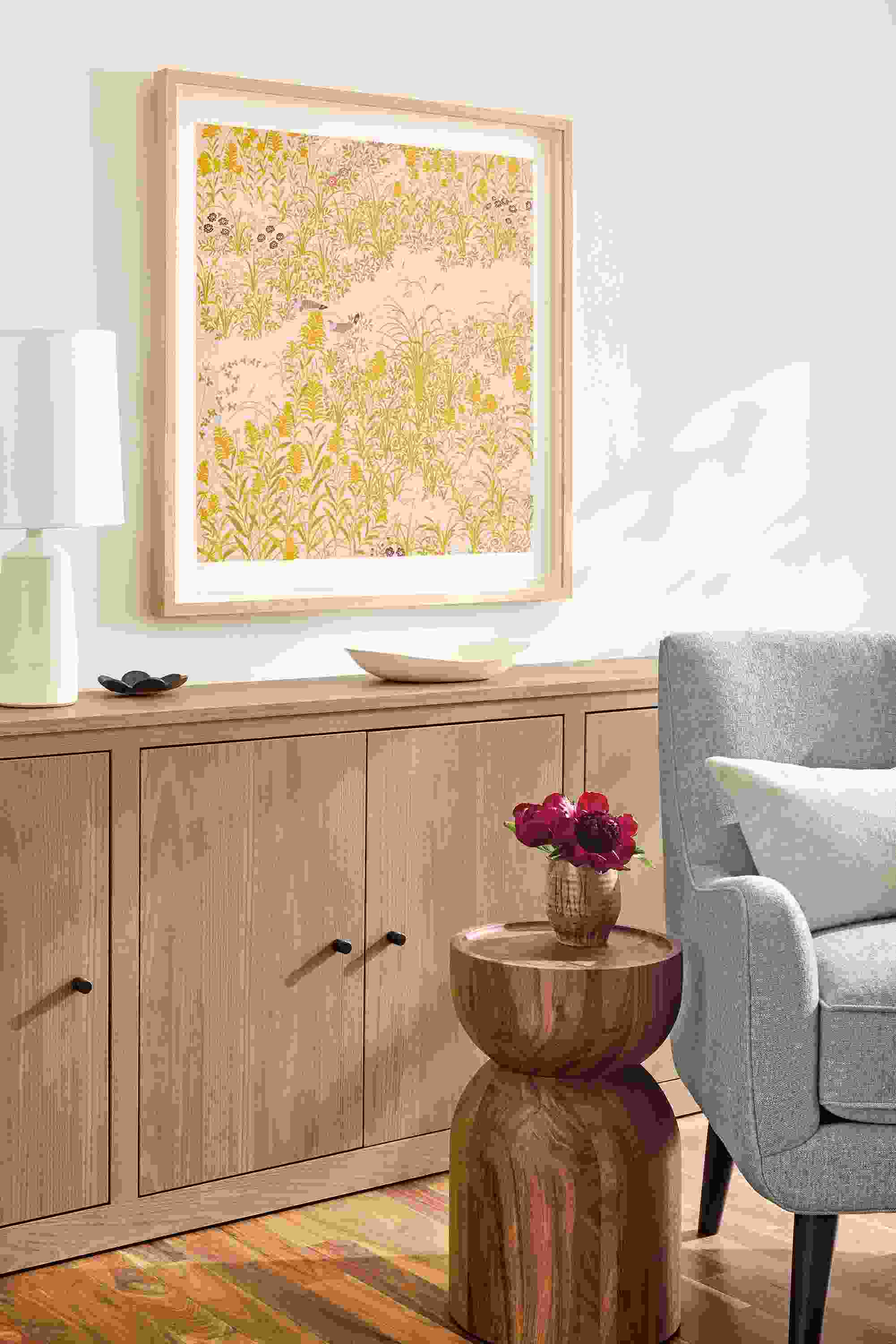 Living room with limited edition 2025 silkscreen edge of field by haruna niiya and 2 woodwind bookcases in rye on red oak.