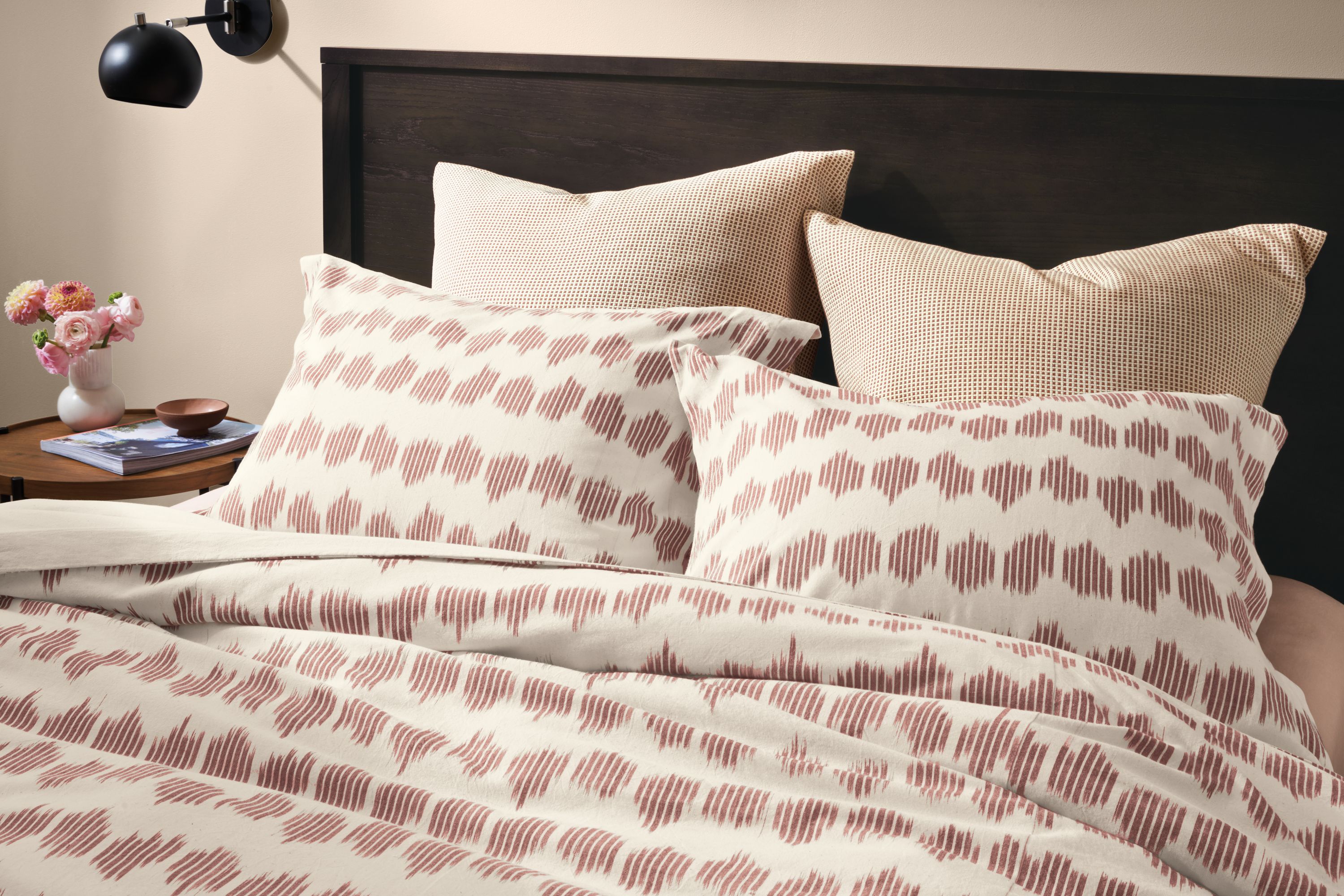 Bedroom setting with Emerson Queen Bed in Charcoal and Nija Duvet set in Brick and Natural.