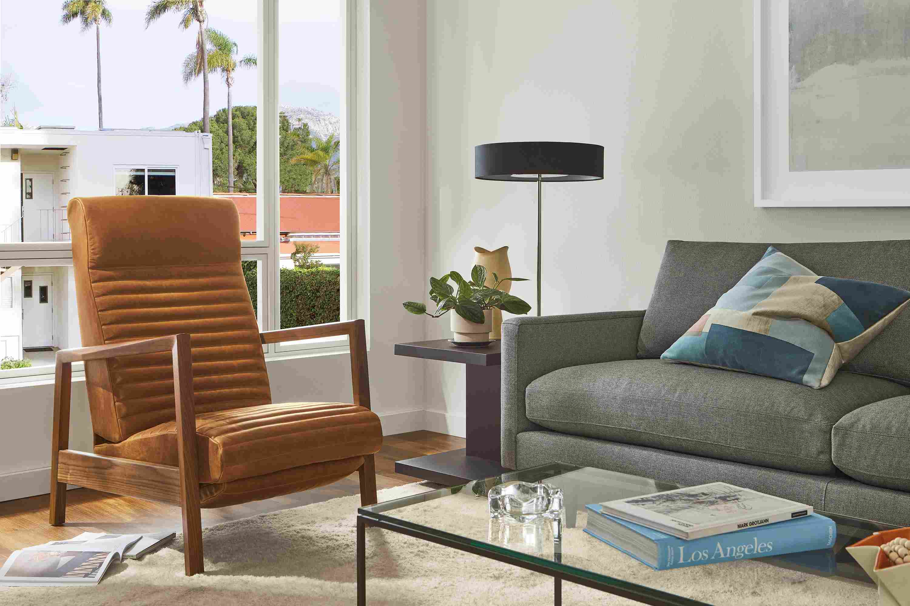Living room with Nilsen recliner in walnut and Cyrus Pecan, Jasper sofa, Cohen table lamp.