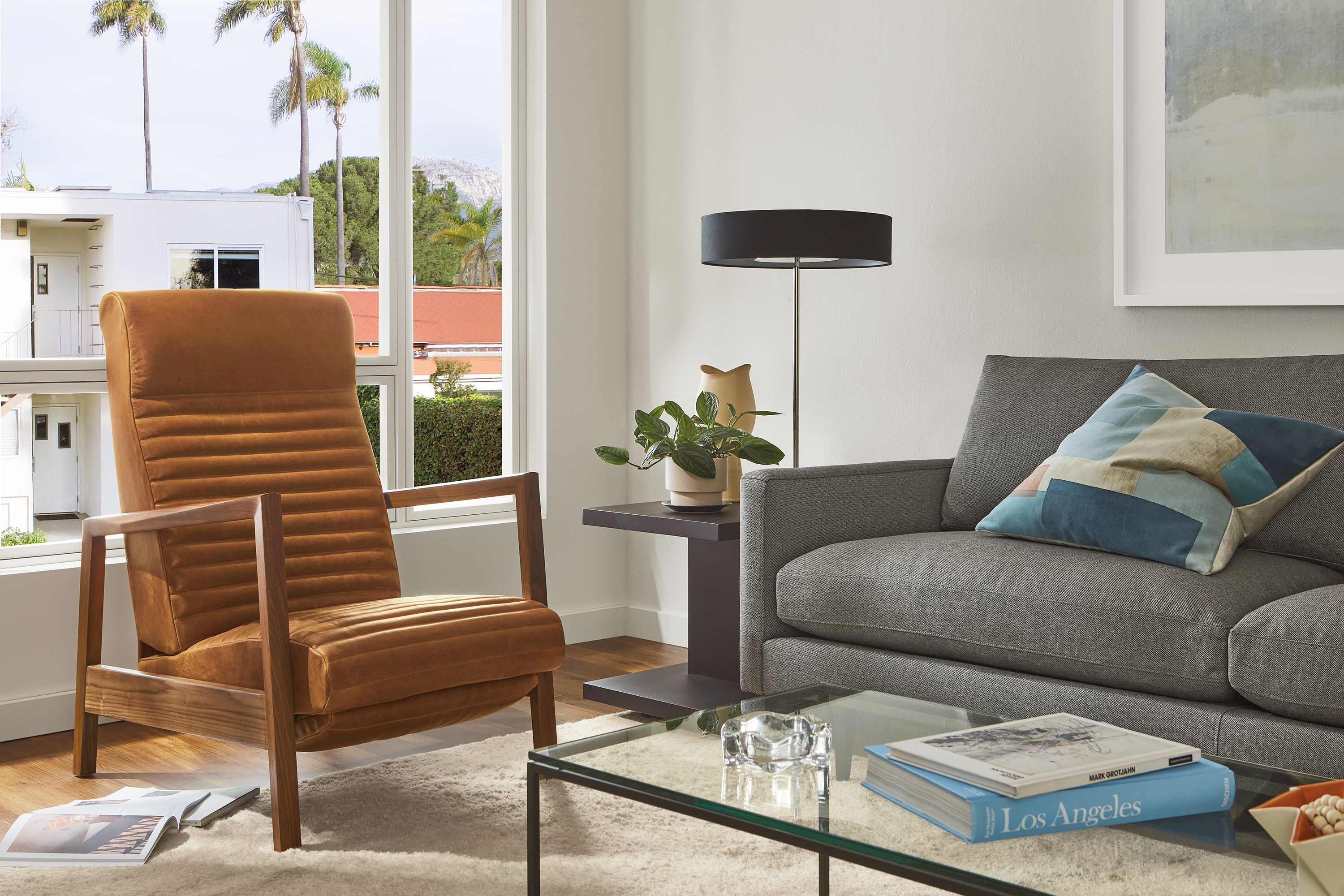 Living room with Nilsen recliner in walnut and leather, Jasper sofa, Cohen table lamp.