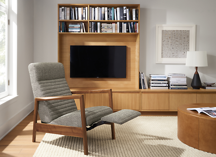 Room setting with Nilsen Recliner in Tatum Fabric and a 
Keaton Media Bookcase with an Arden Ribbed Rug in Oatmeal.