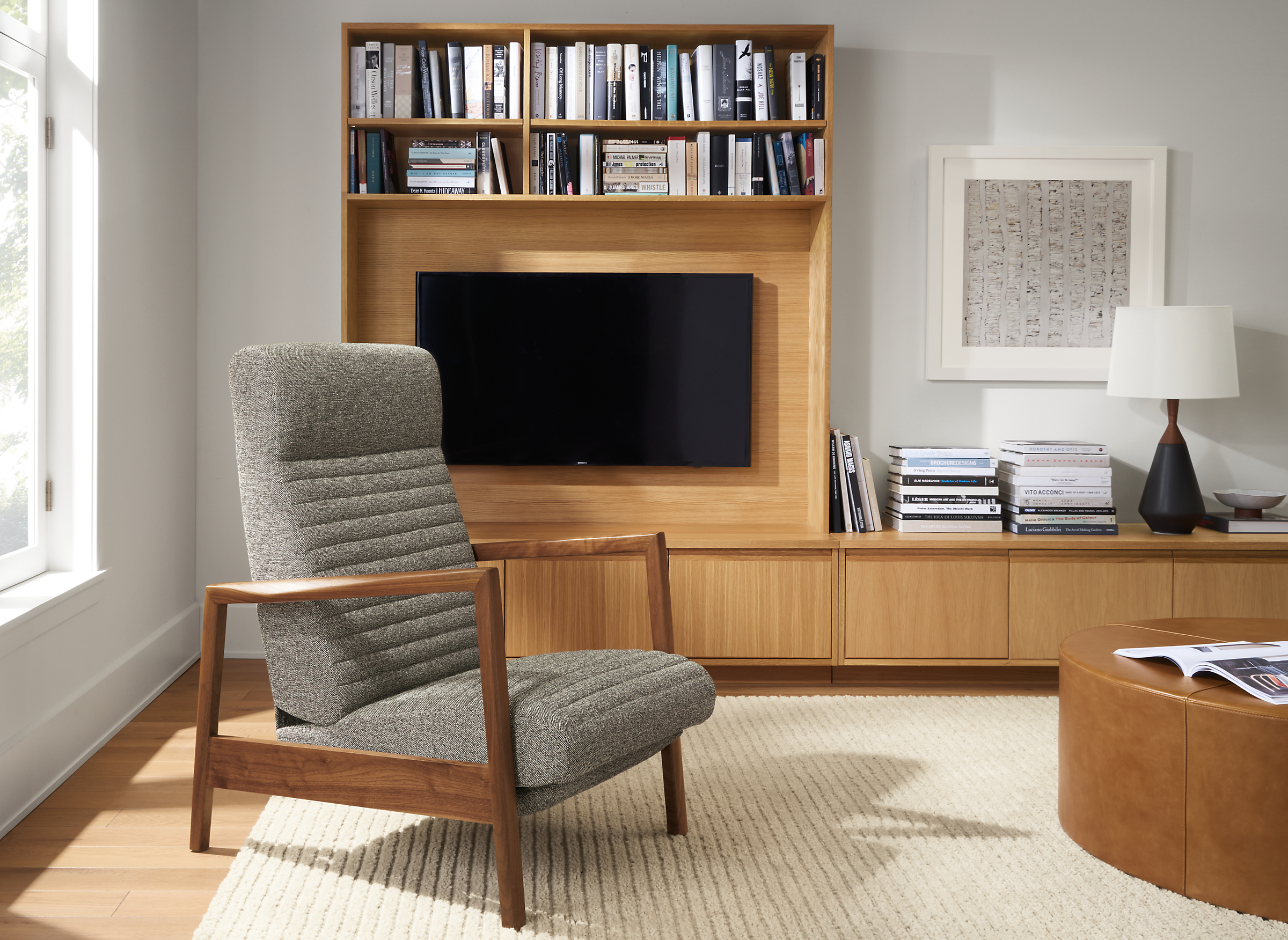 Room setting with Nilsen Recliner in Tatum Fabric and a 
Keaton Media Bookcase with an Arden Ribbed Rug in Oatmeal.