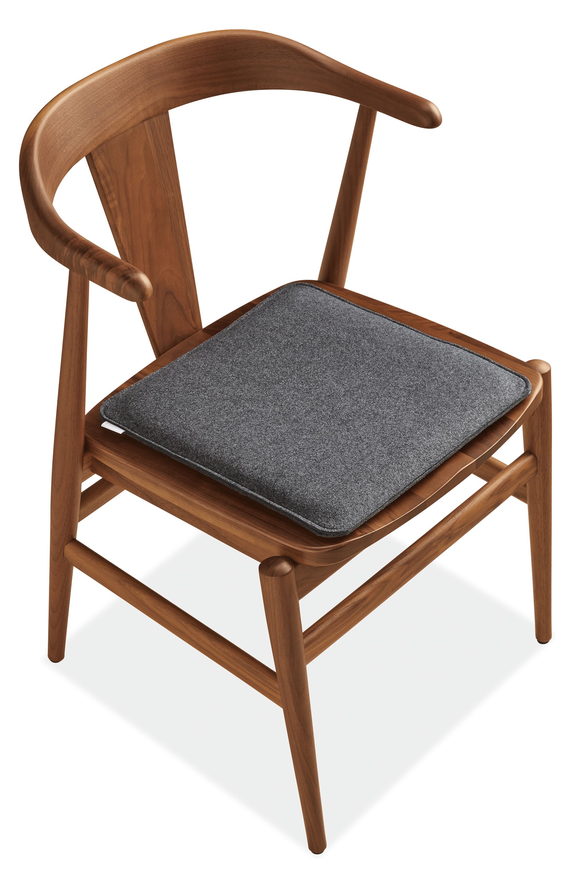 Detail of Nina 15-Square Seat Cushion in Felt Charcoal on Evan Arm Chai.