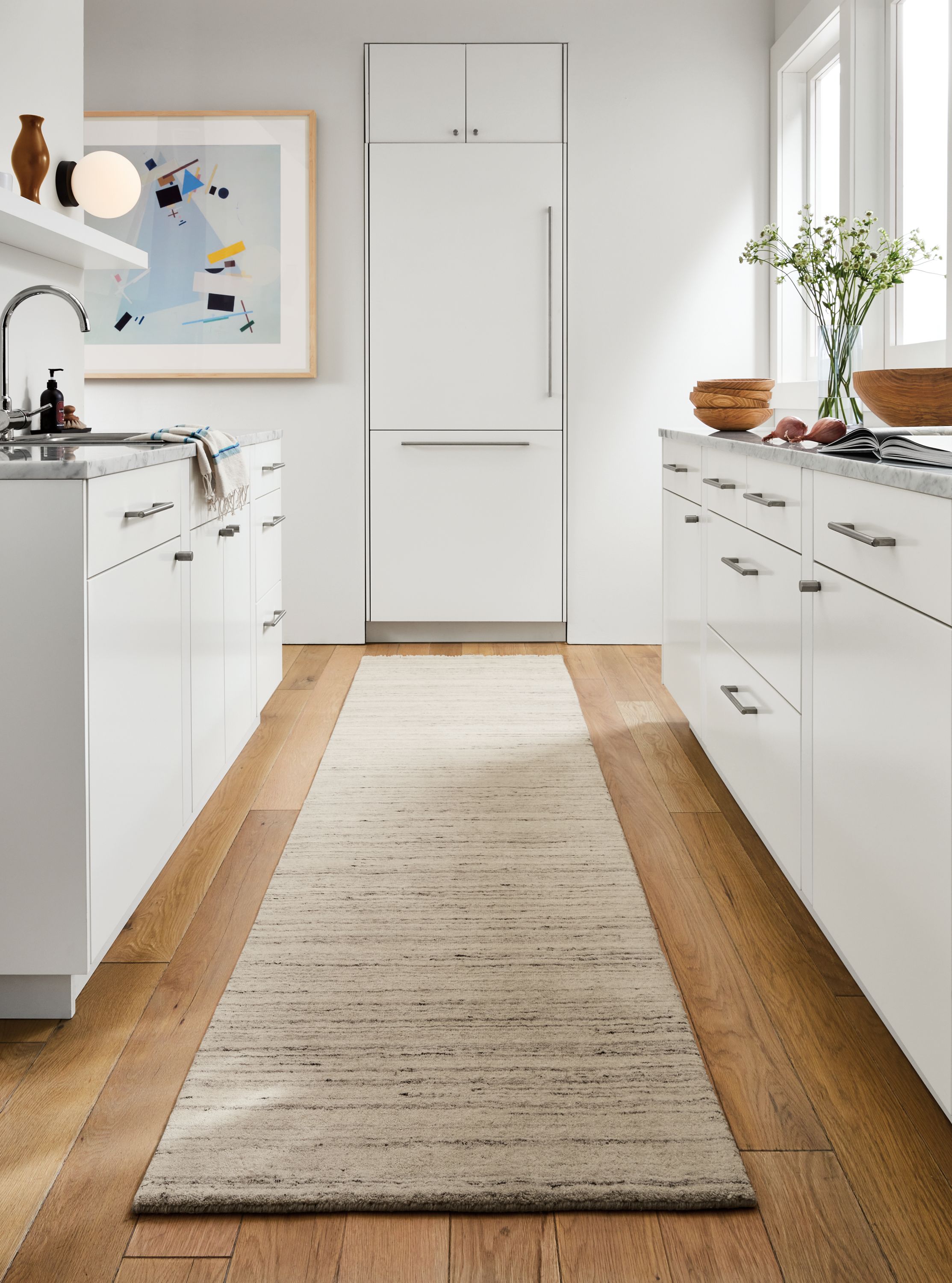 Kitchen room setting with Nomad rug in Ivory and Grey, Float Wall Shelf and Orbit Wall Sconce.