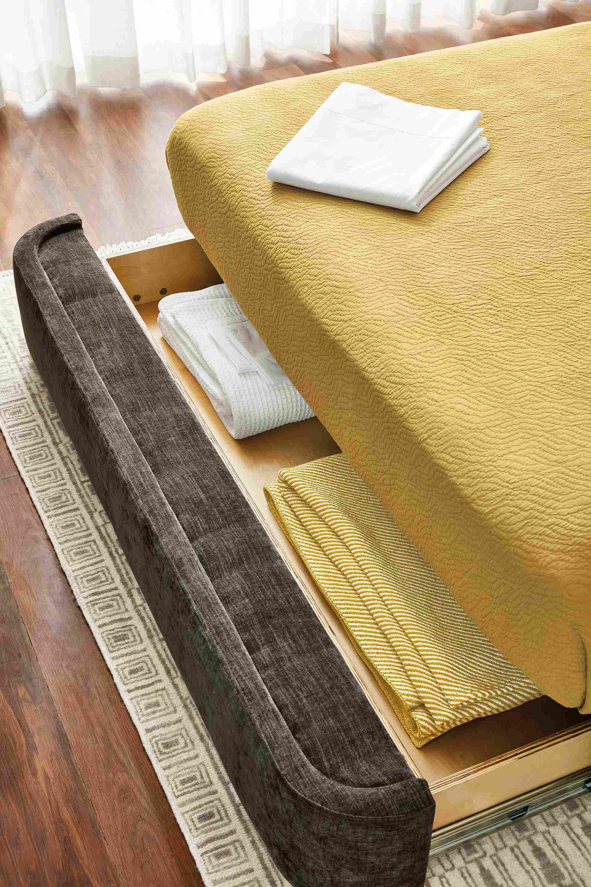 detail of nora storage bed drawer extended showing interior storage.