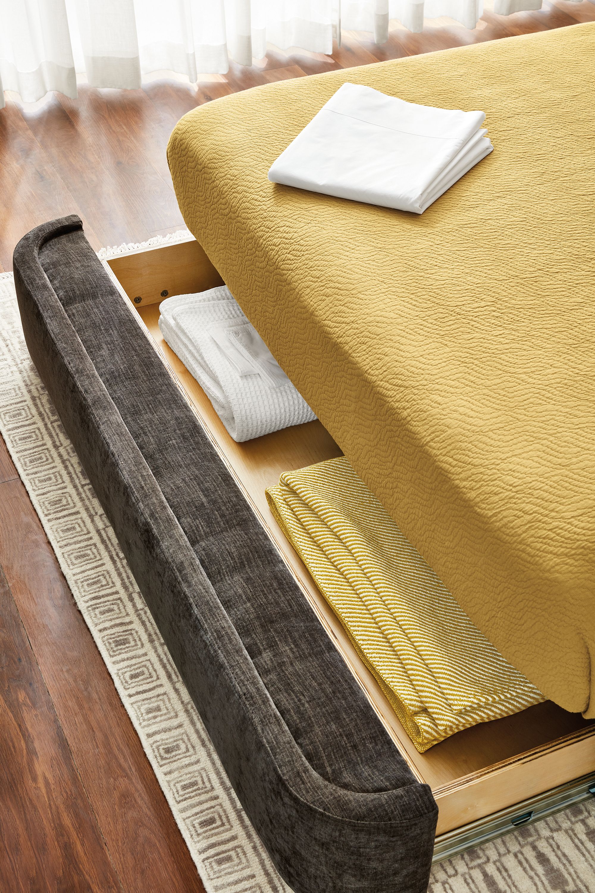 detail of nora storage bed drawer extended showing interior storage.