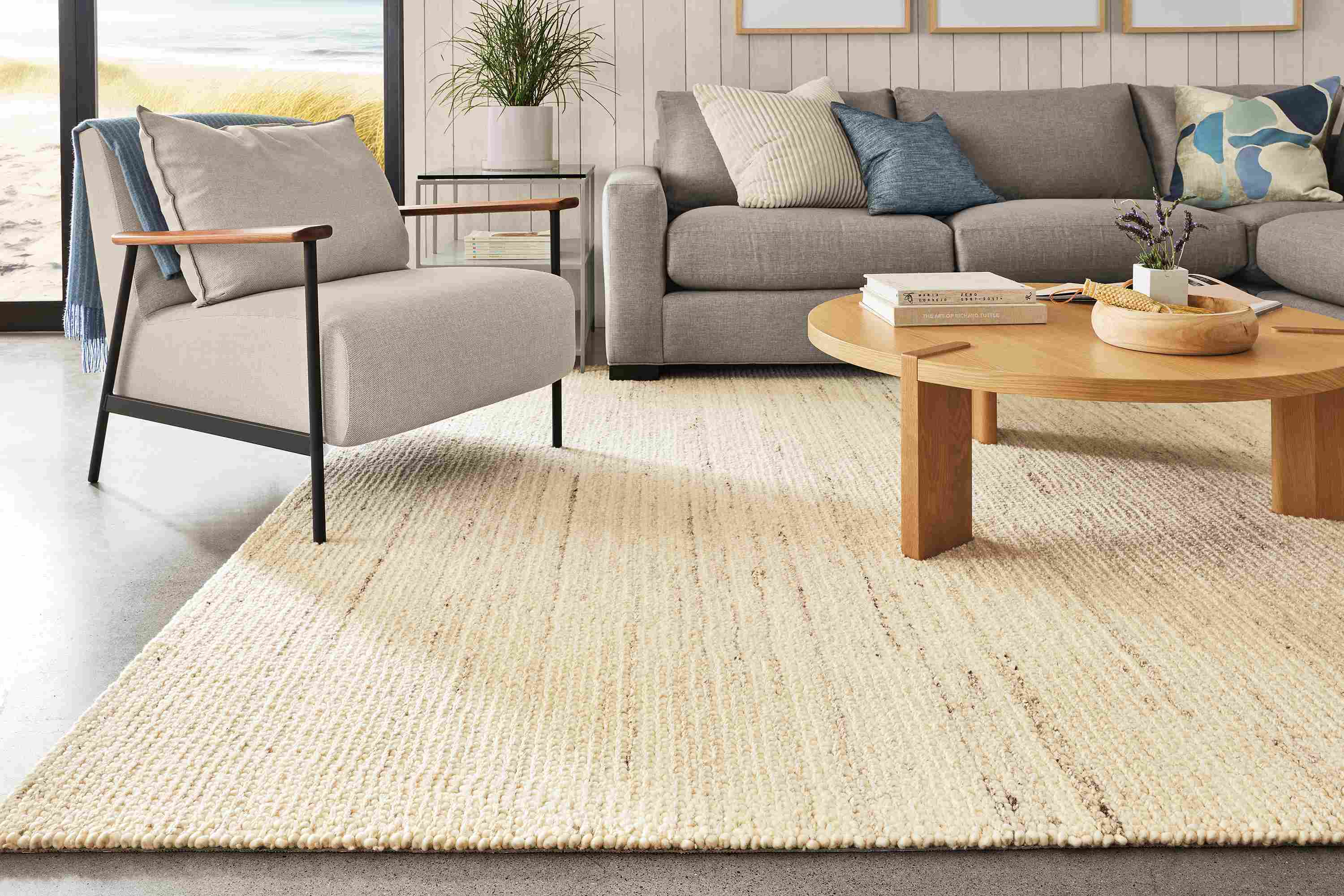living room with norfolk rug in cement, xavier chair in gino oatmeal and hanover coffee table.