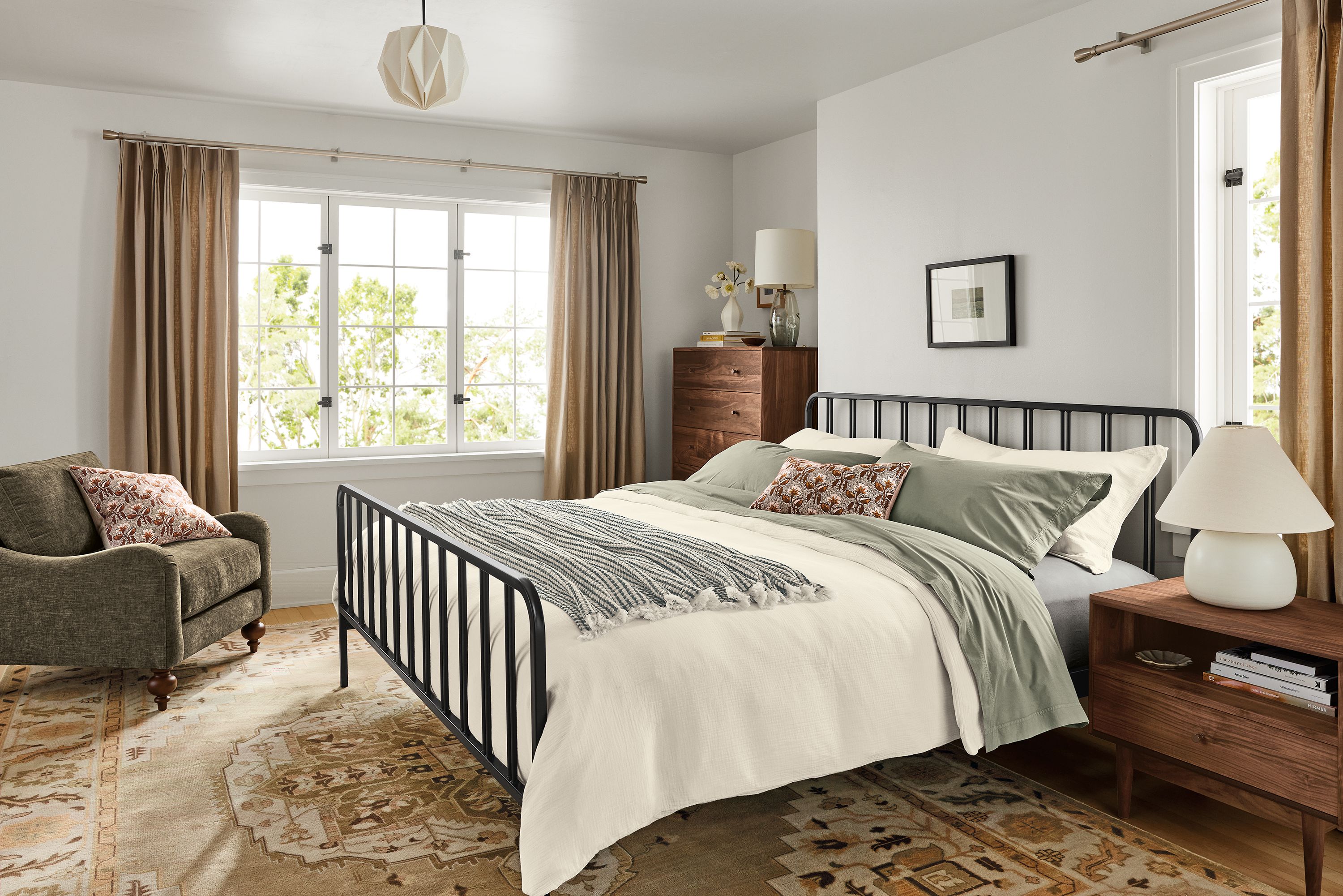 Bedroom with Northrup king bed in natural steel, Grove nightstand and dresser in walnut and Heriz rug in opal.