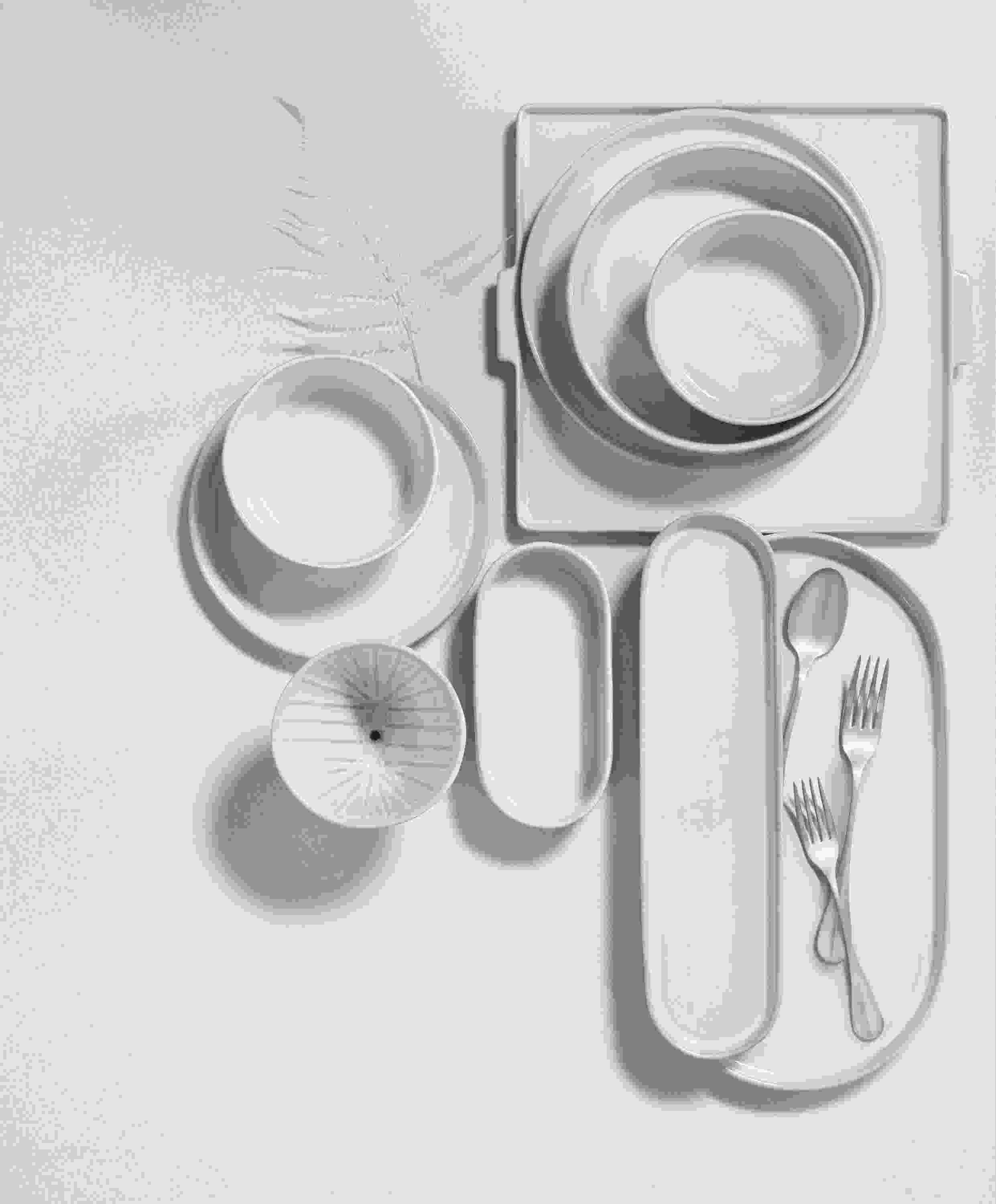overhead view of notos dishware in white stacked on tabletop.