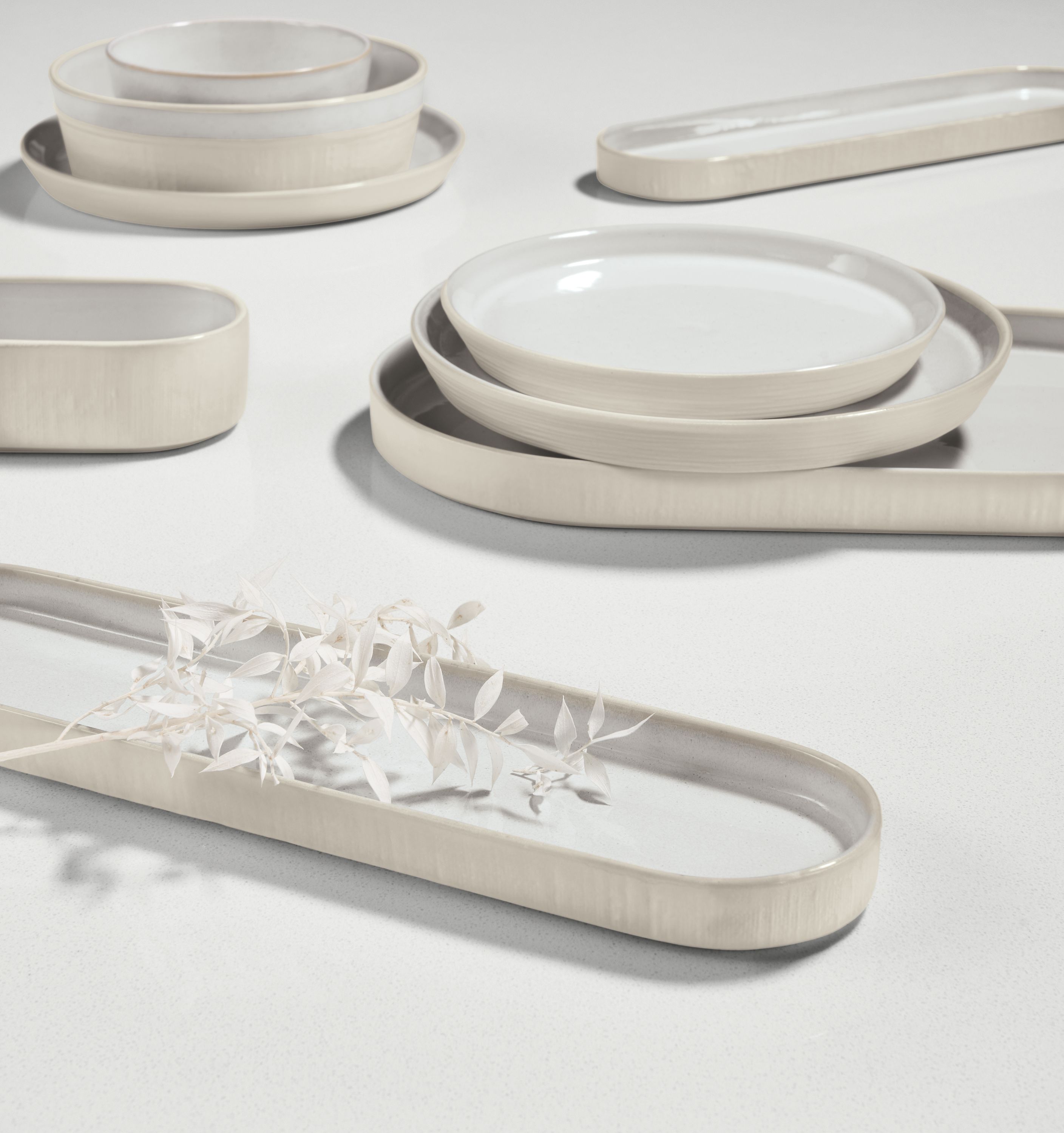 notos dishware in white stacked on tabletop.