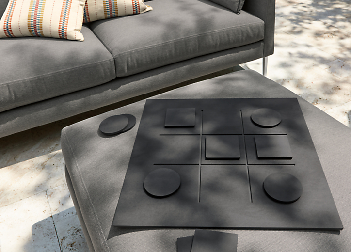 Noughts tic tac toe game in slate with Palm outdoor sectional and ottoman.