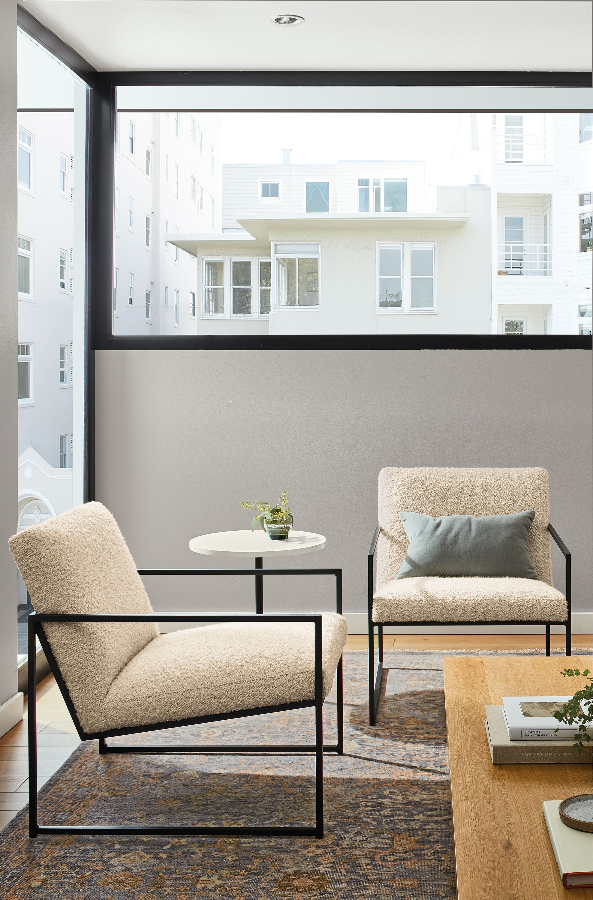 living room with two novato chairs with white boucle fabric.