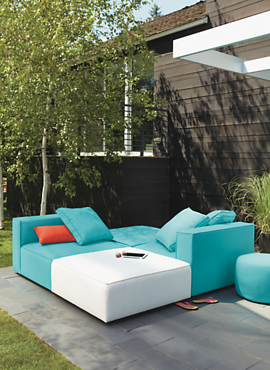 Outdoor patio setting with Oasis armless chairs and ottomans with Outdoor pillows.  