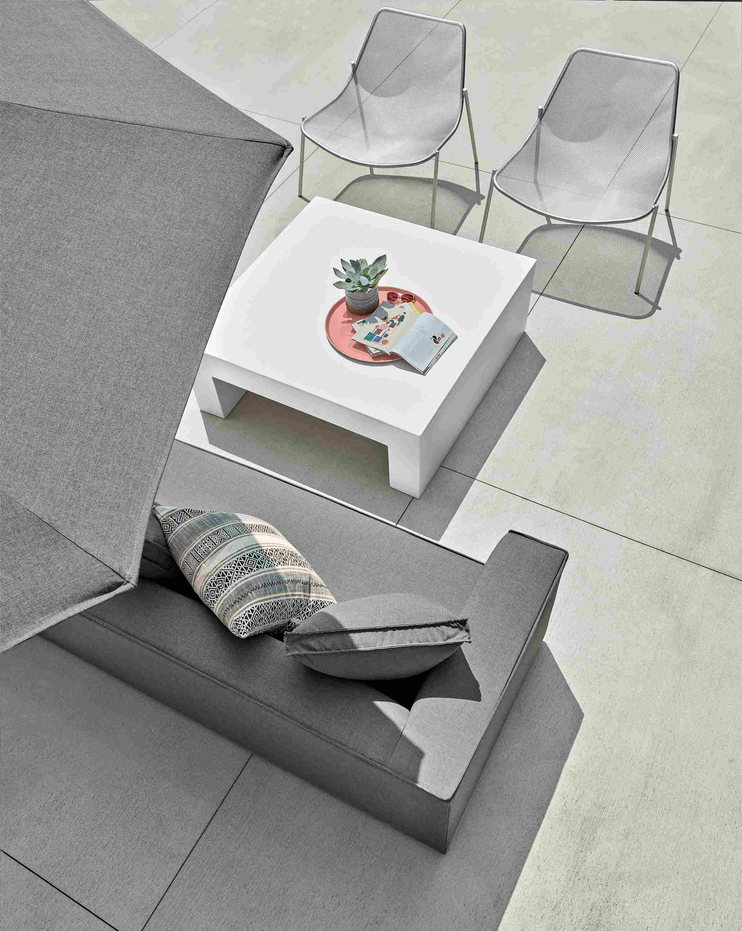 Outdoor patio setting with Oasis sofa and Vignelli coffee table and Solieil lounge chair.