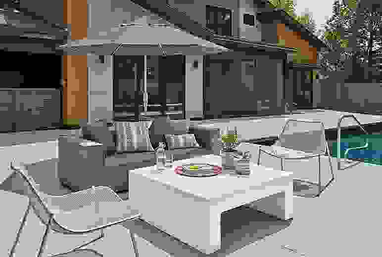 Outdoor patio setting with Oasis sofa and Vignelli coffee table and Solieil lounge chair.