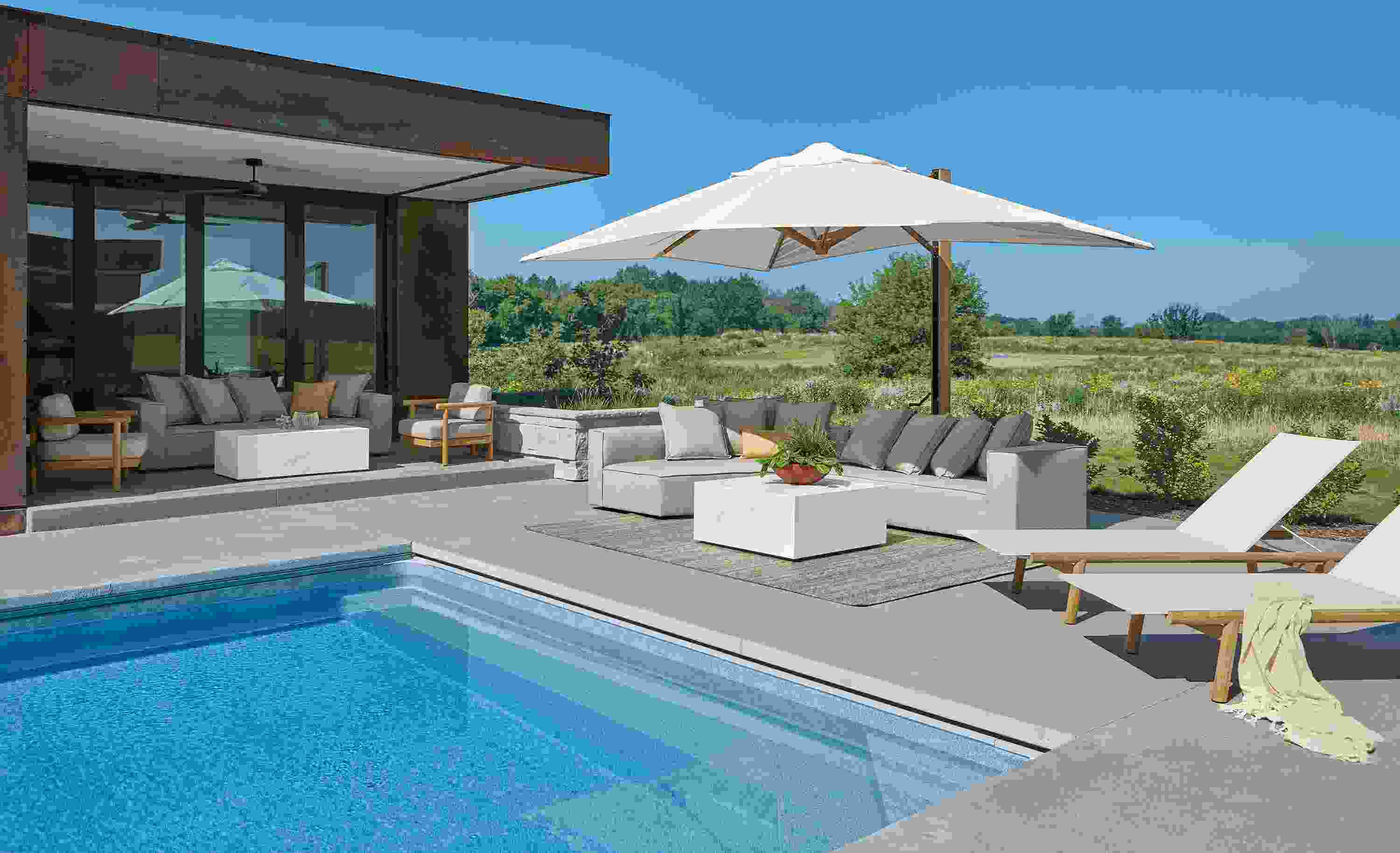 Pool with Oasis right arm sofa in Mist Oatmeal and 2 Isley chaises in teak heartwood with salt outdoor sling.