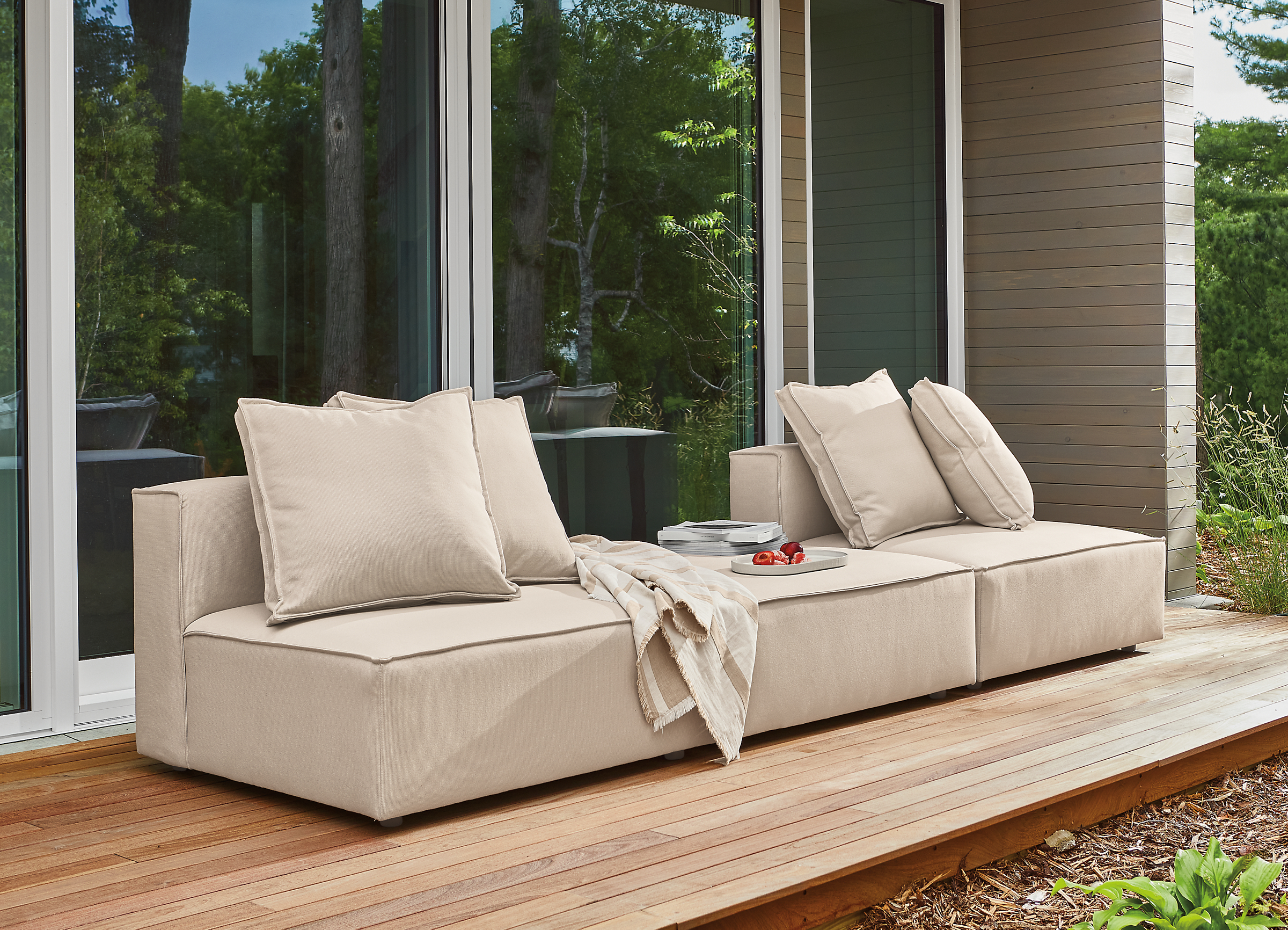 Outdoor space with Oasis armless chairs and Oasis ottoman.