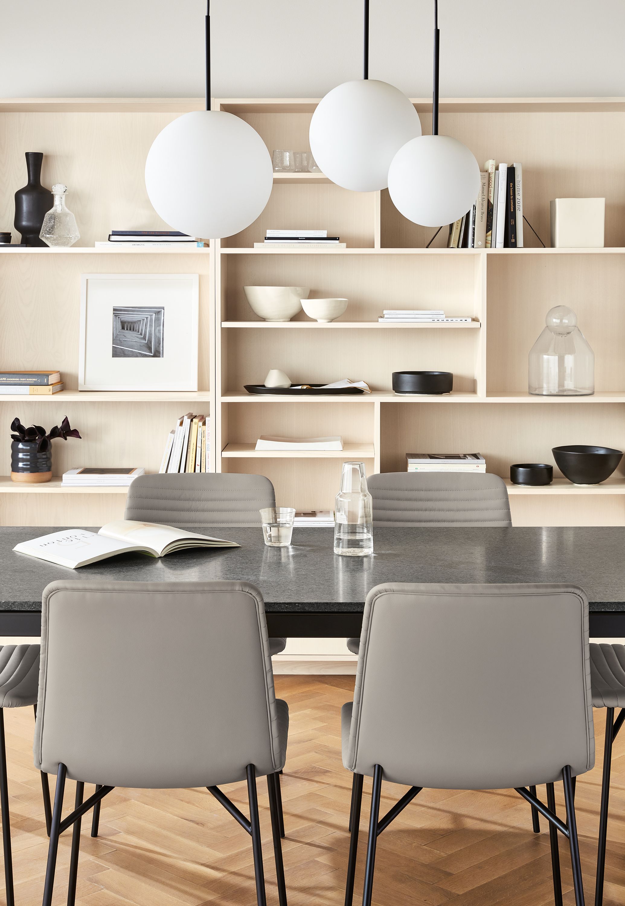 Orbit 8,10, and 12-inch diameter pendants hanging above a Parsons table.