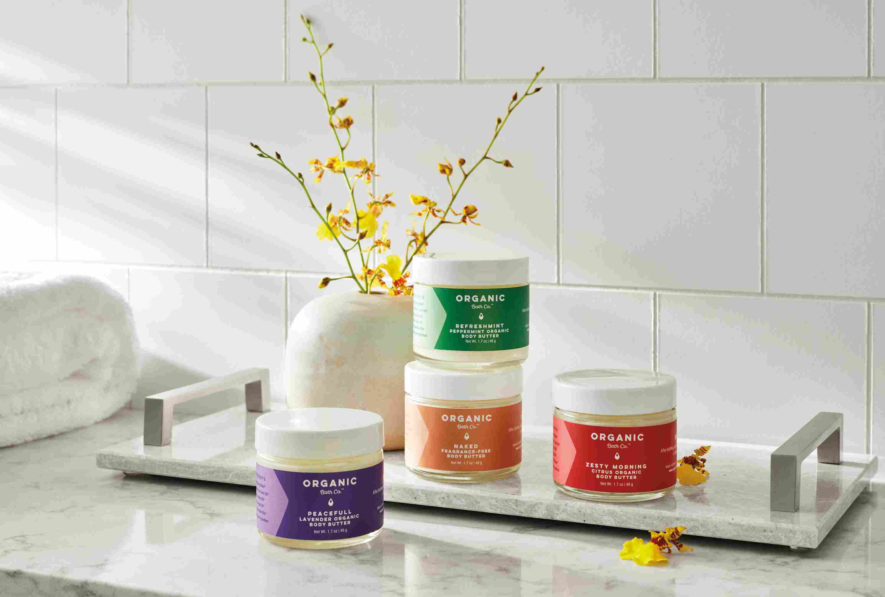 detail of organic bath company body butter jars on halsted serving tray.