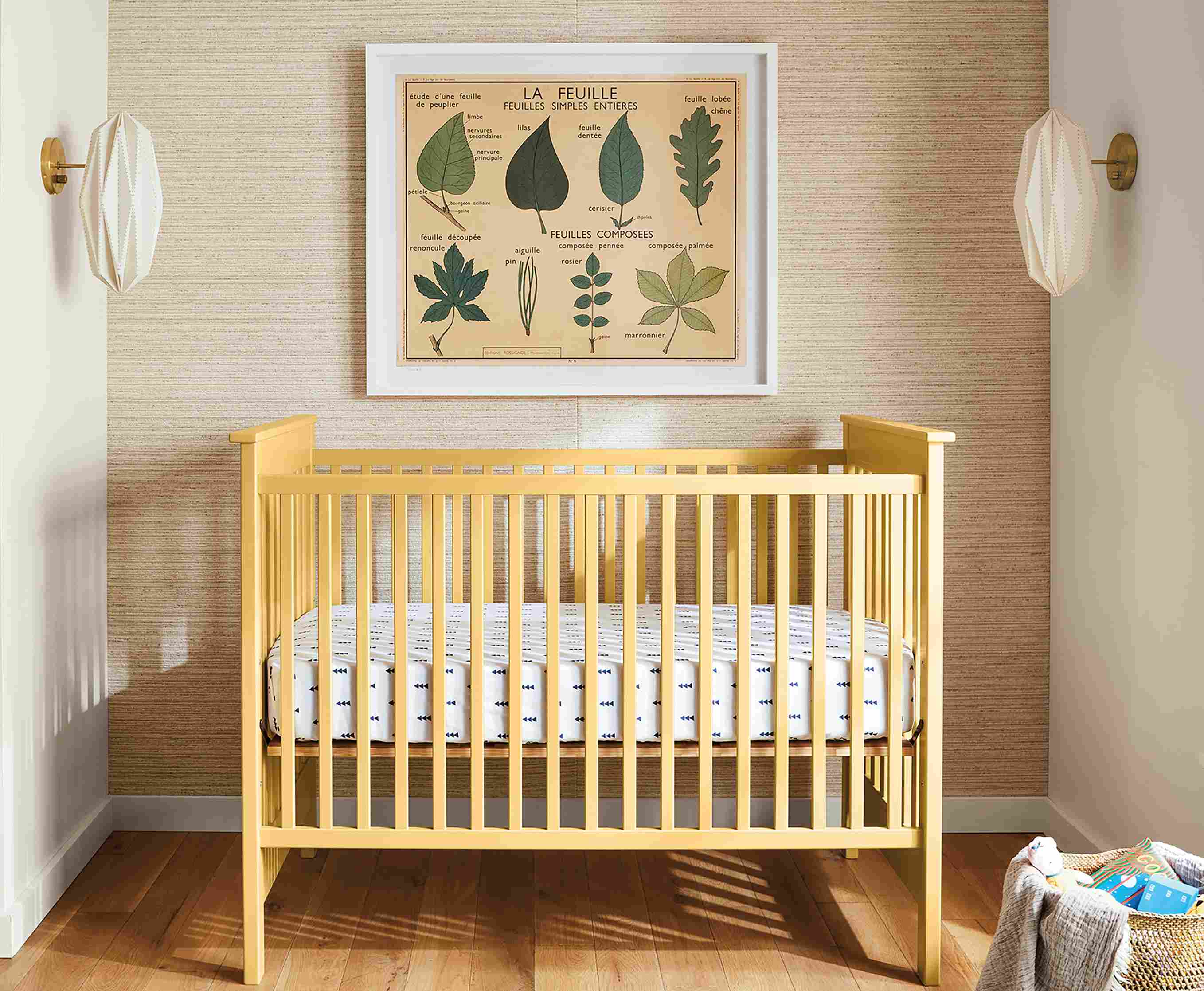 Room setting with a Nest crib and two Orikata wall sconces.