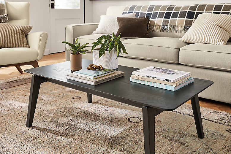 Room setting with an Orlin Coffee Table with York Sofa in Sumner Linen and a Boden Chair in Urbino Leather.