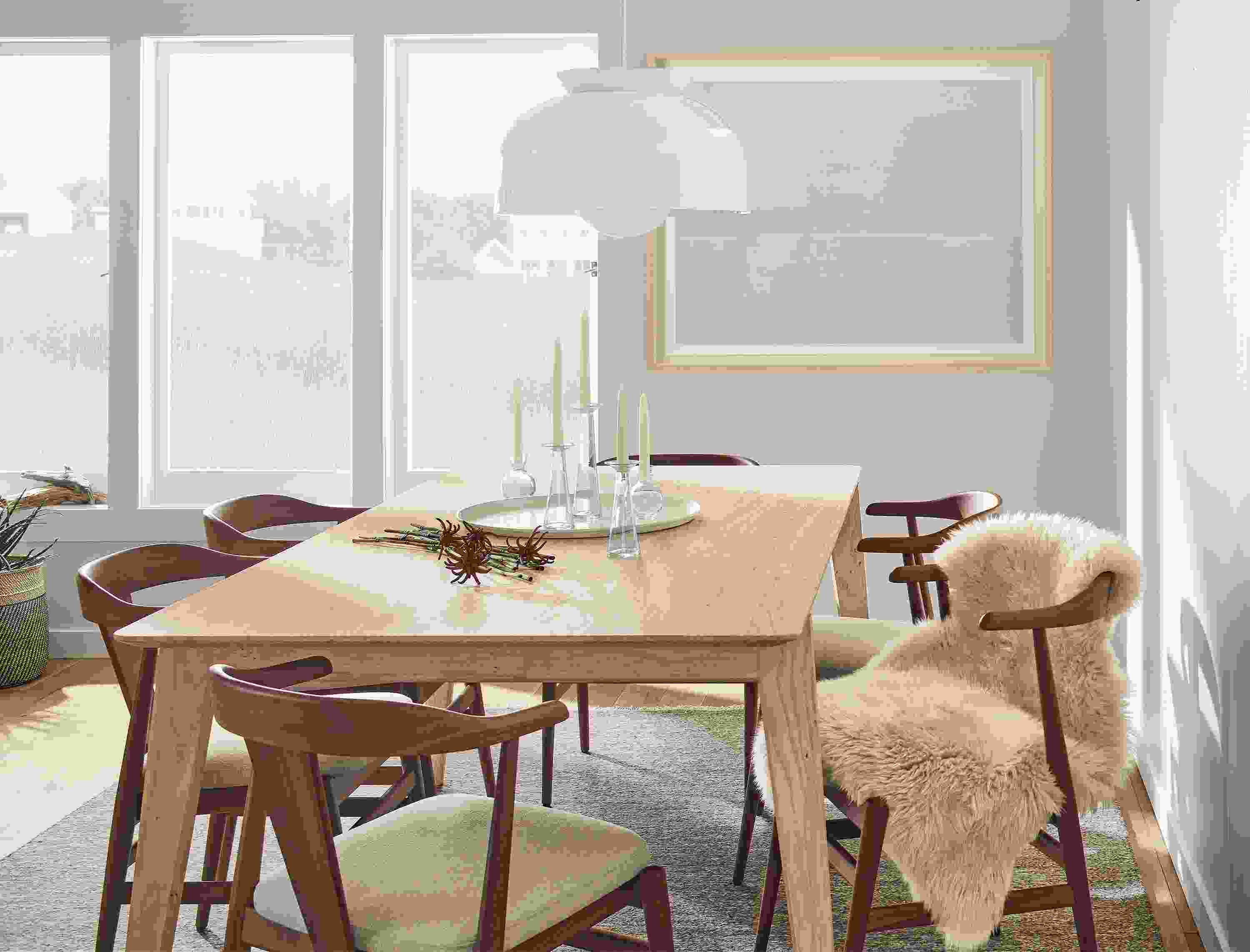 Dining room with Orlin 80 by 40-inch table in ash with Evans arm chairs in walnut with Myers Taupe fabric and Bray pendant in white.