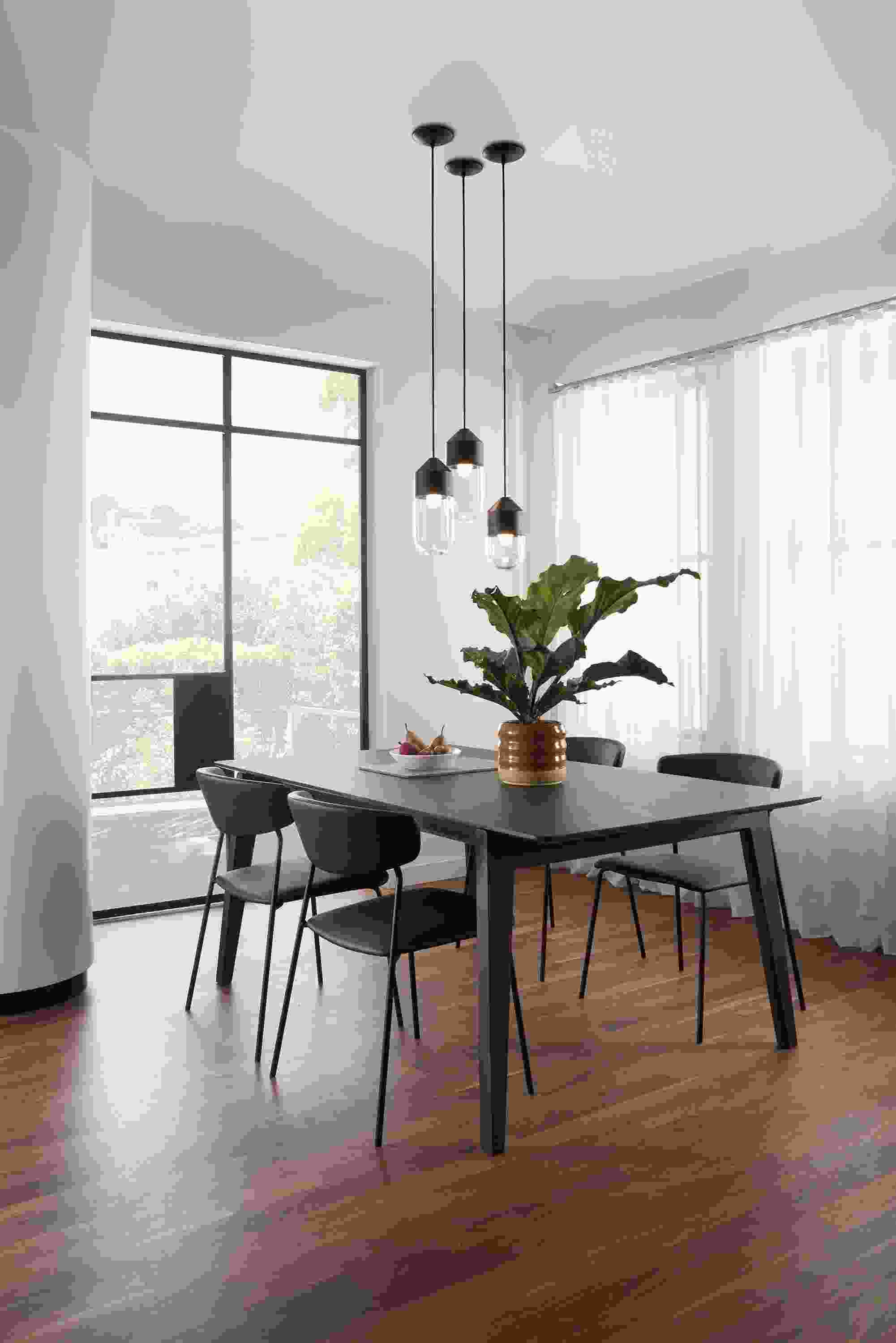 Room setting with an Orlin Dining Table and Wolfgang Chairs with a Ballad pendant grouping.