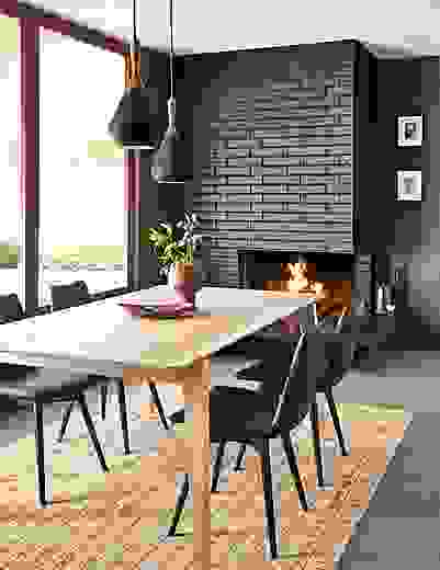 dining room with fireplace featuring orlin table in ash with arthur dining chairs in black