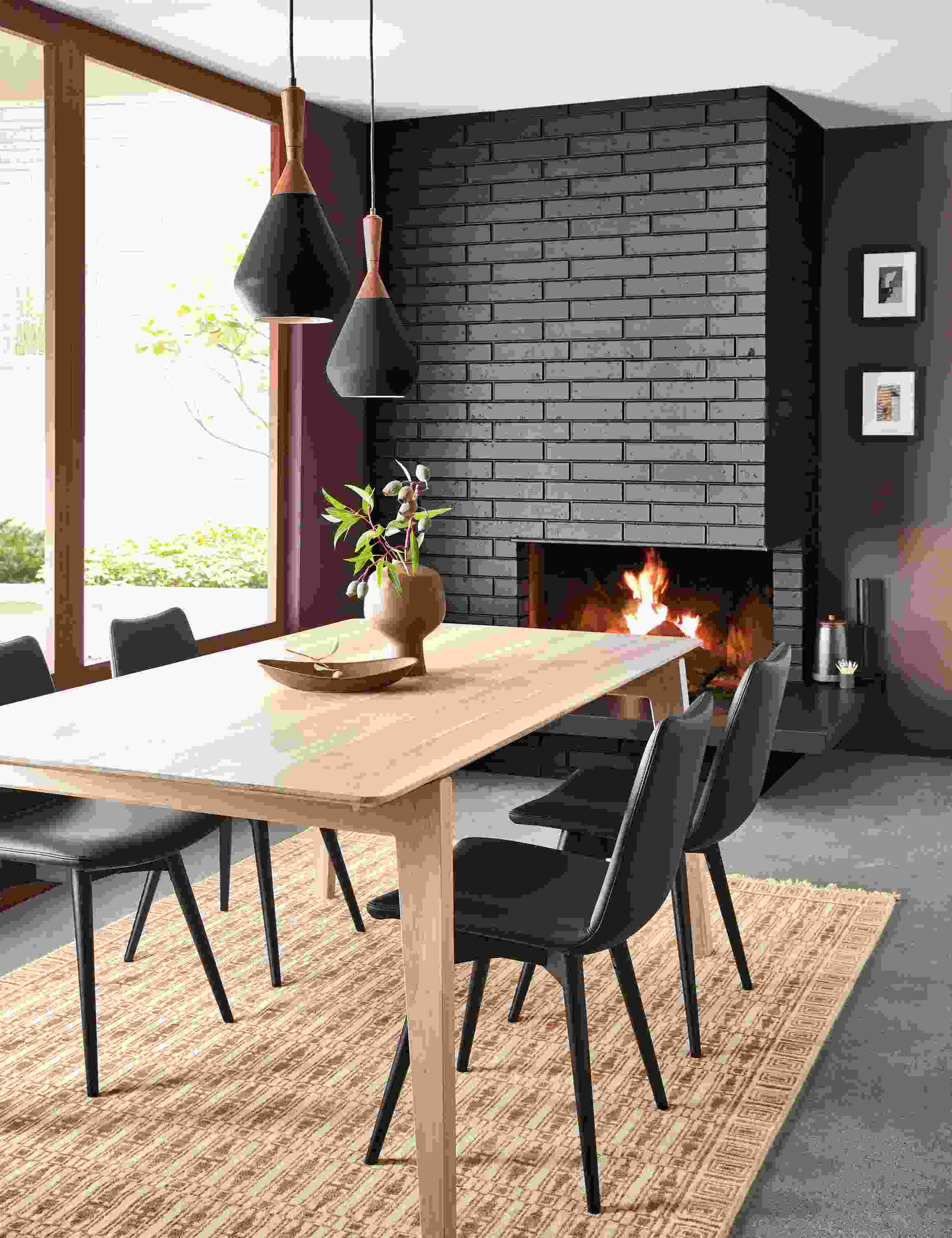dining room with fireplace featuring orlin table in ash with arthur dining chairs in black