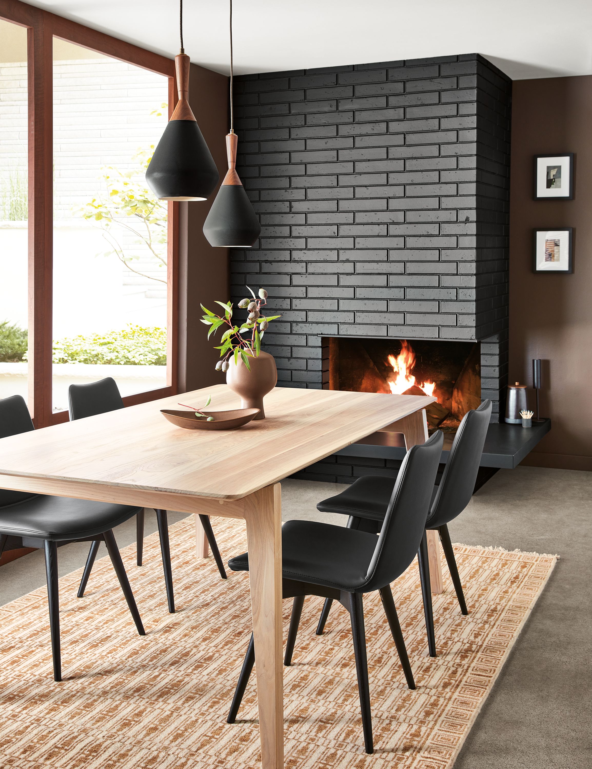 dining room with fireplace featuring orlin table in ash with arthur dining chairs in black