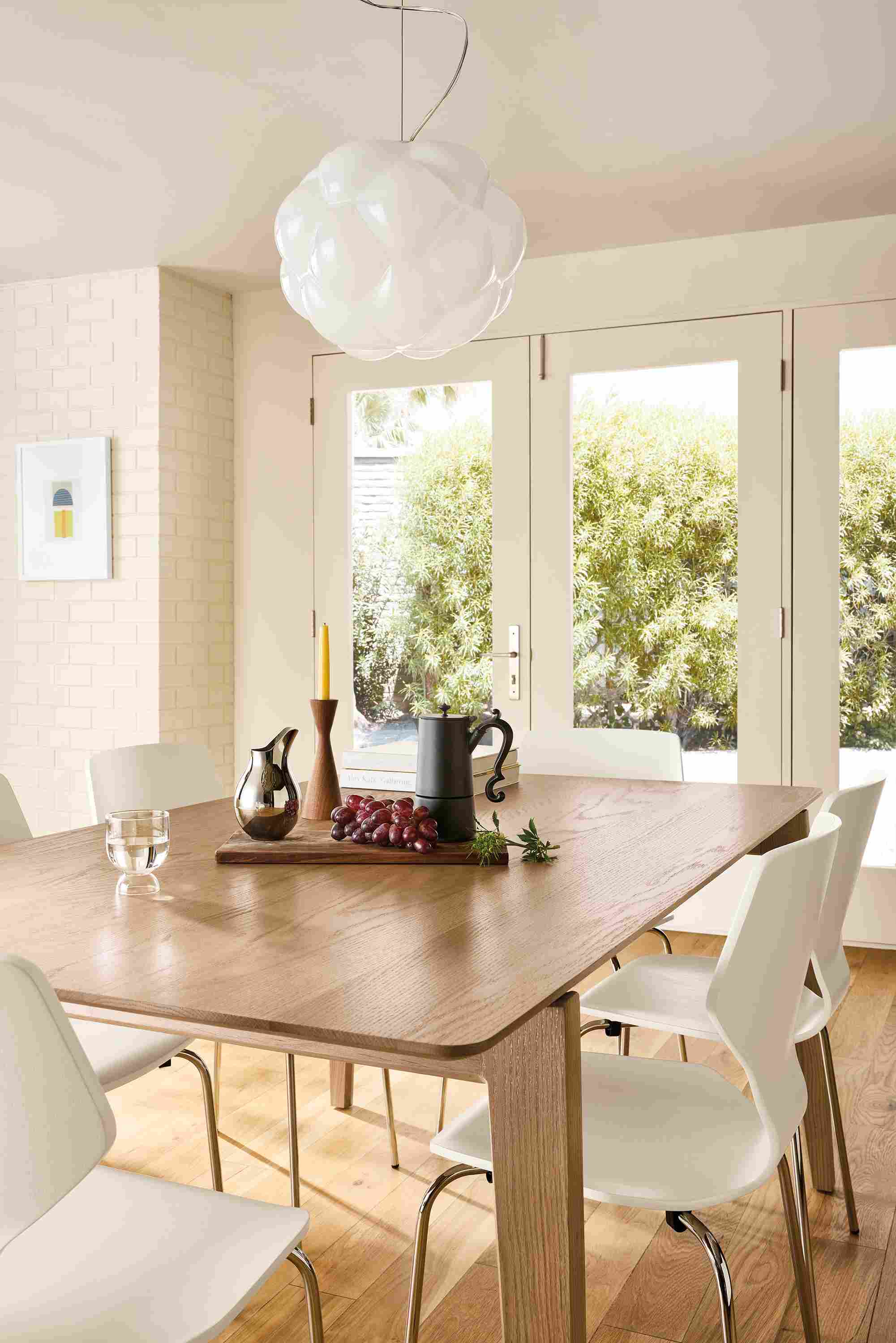 Dining room with Orlin 70-wide table in rye on red oak and 6 pike chairs in white with chrome legs.