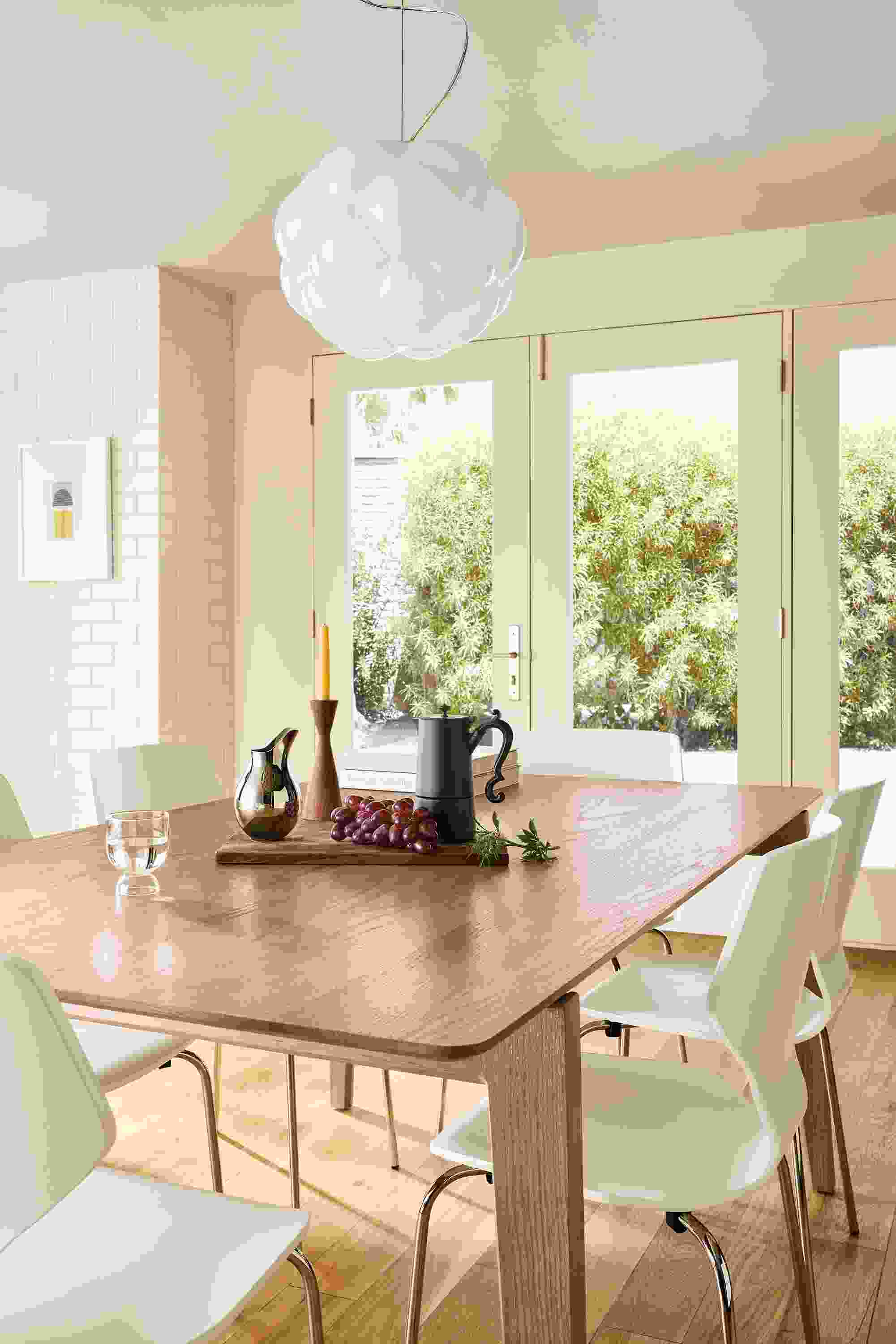 Dining room with Orlin 70-wide table in rye on red oak and 6 pike chairs in white with chrome legs.