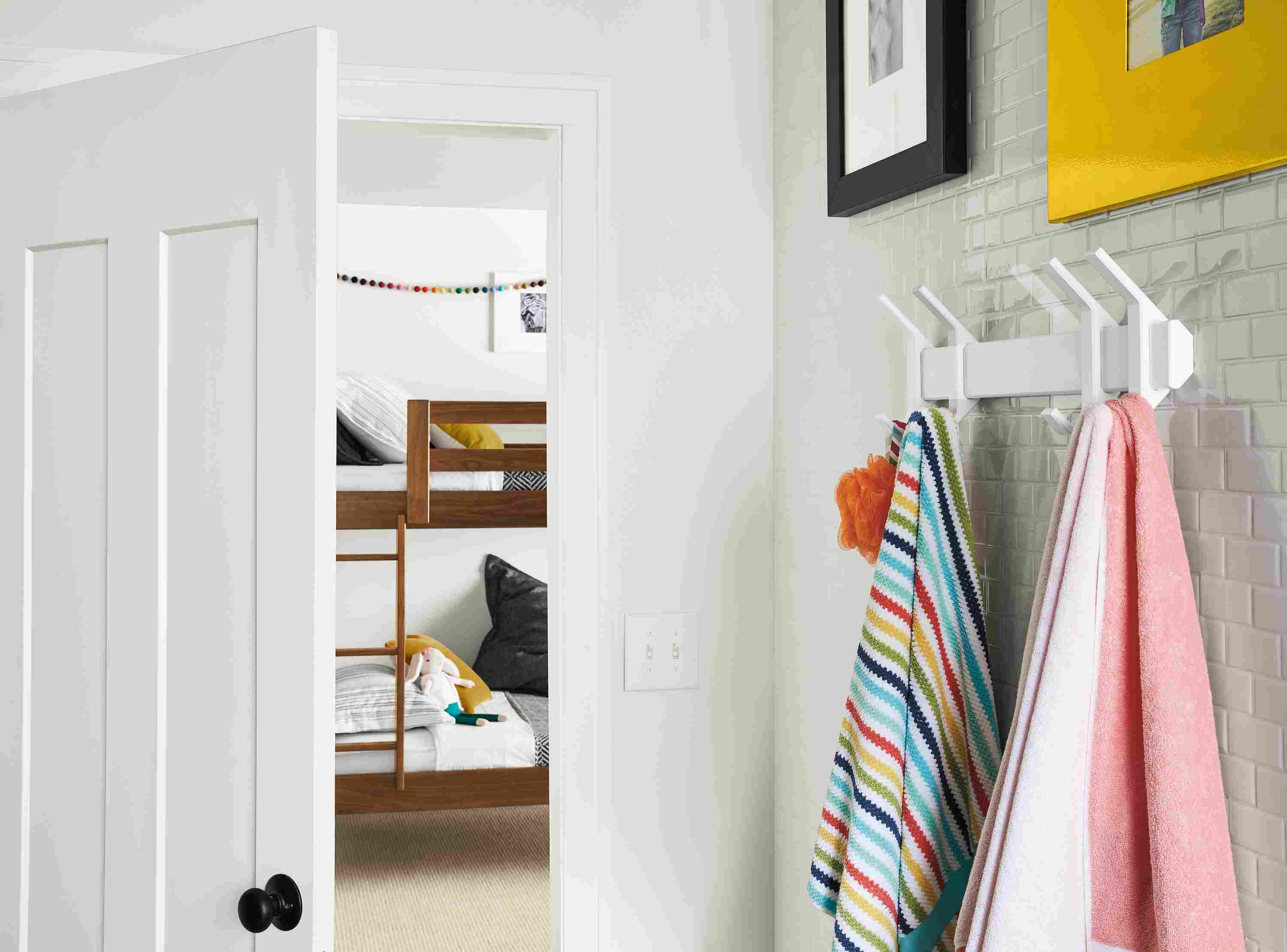 Detail of Orr multiple wall hooks in white with two hooks on left and two on right.
