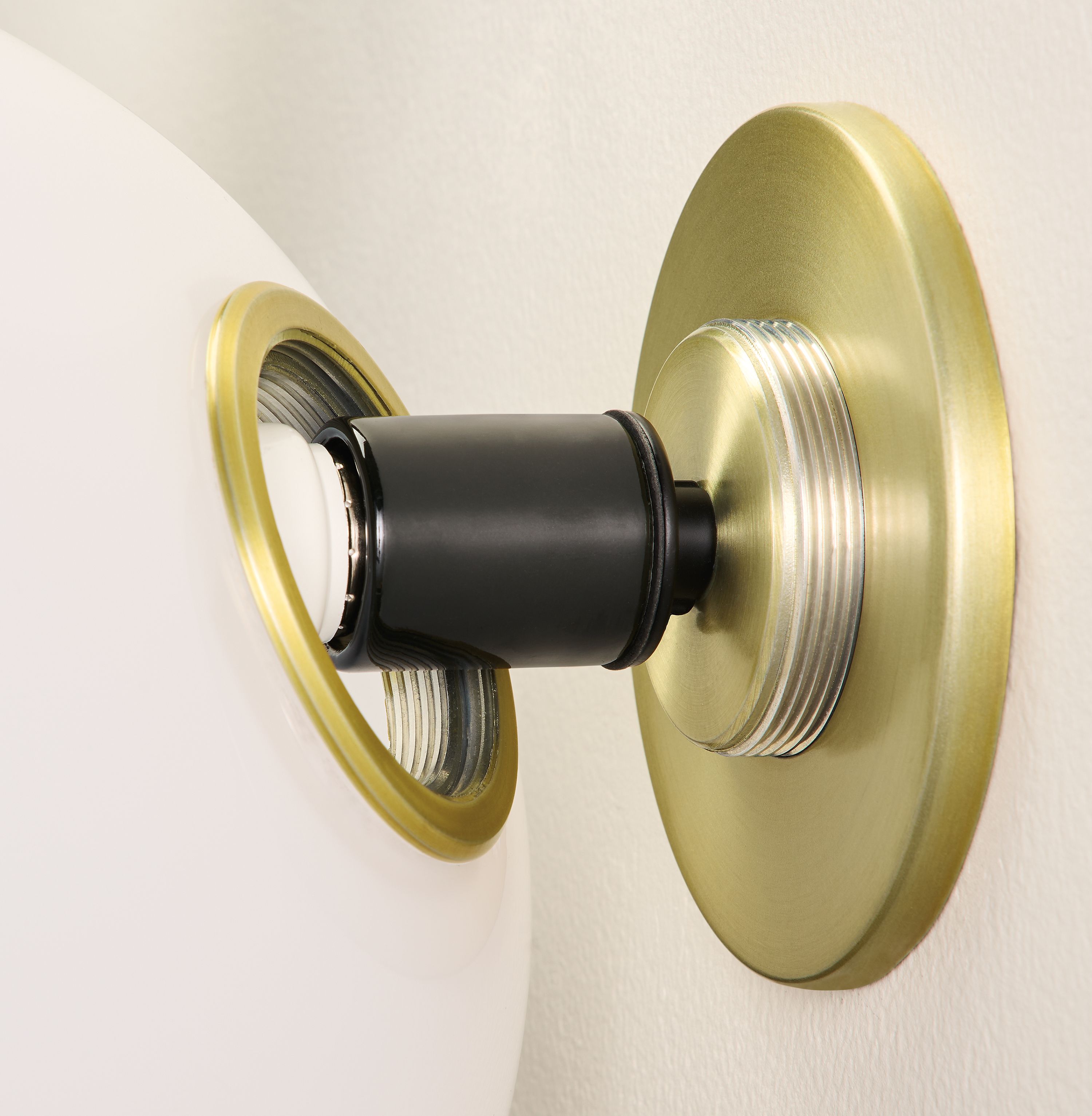 Osiris globe wall sconce in opal glass and brushed gold showing threaded mounting plate and mounting ring.