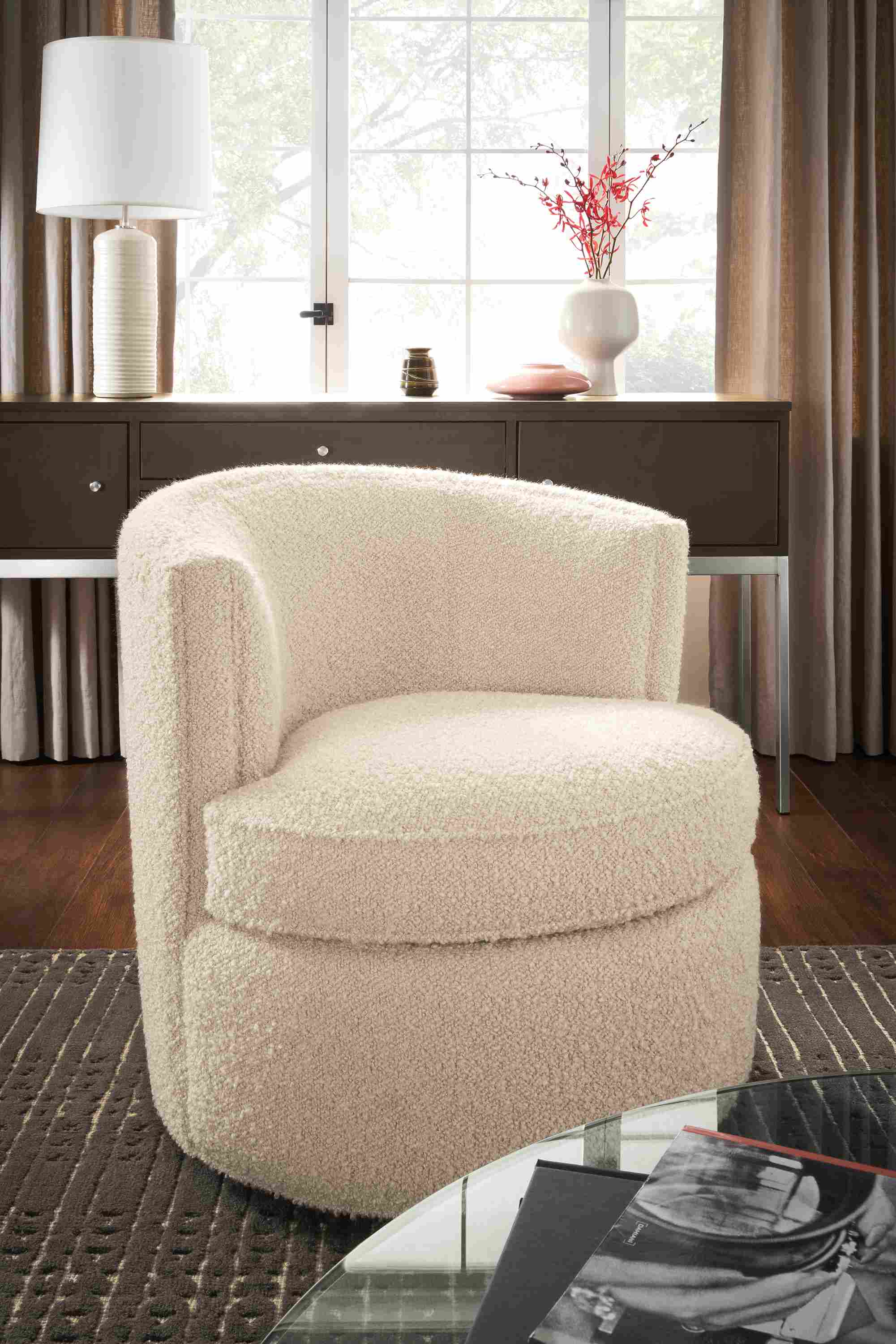 Living room with Otis swivel chair in Dornick Ivory fabric and Bria 8 by 10 rug in charcoal.