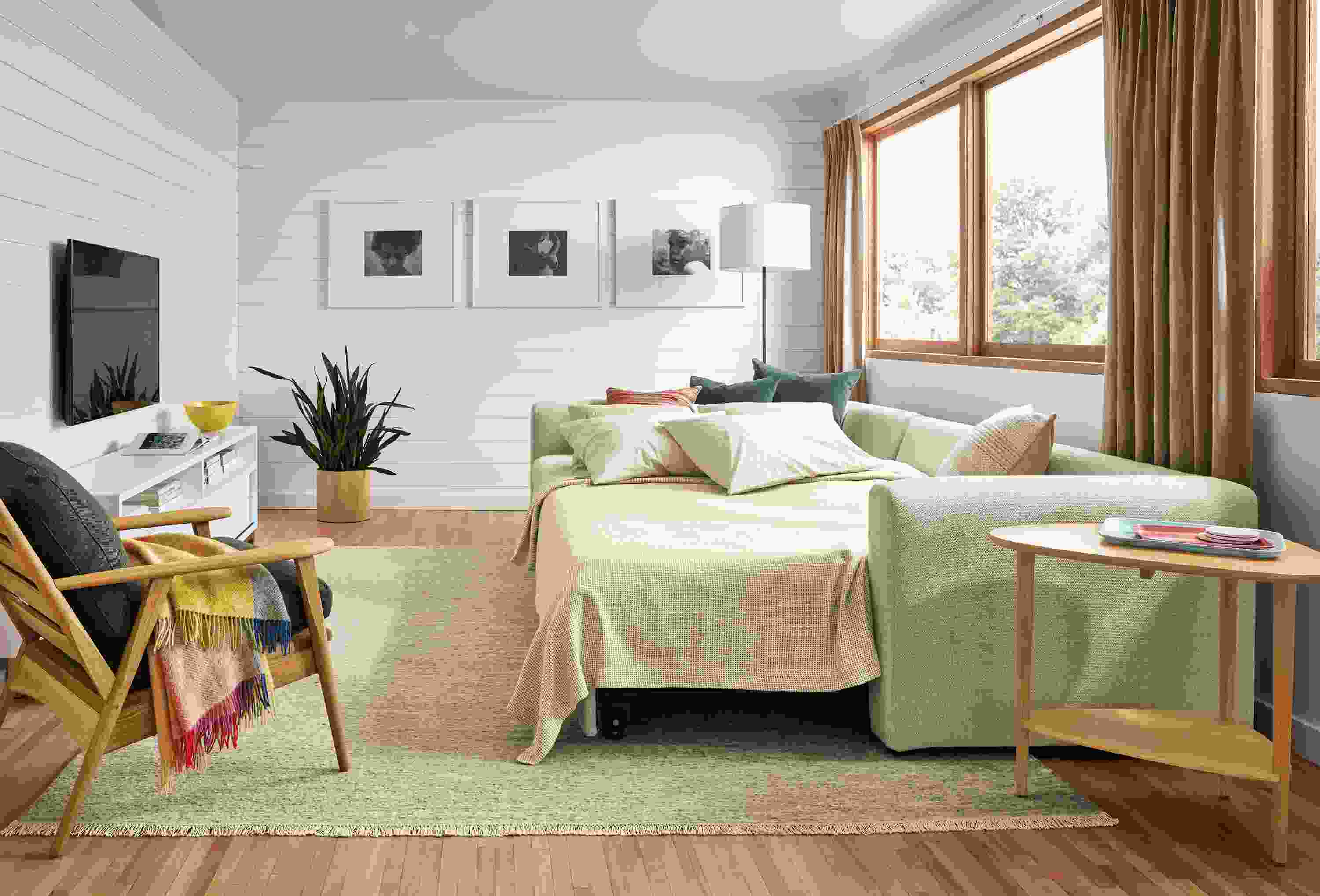 Living room with Oxford sleeper sofa in Orla Ivory with platform extended and bed made.