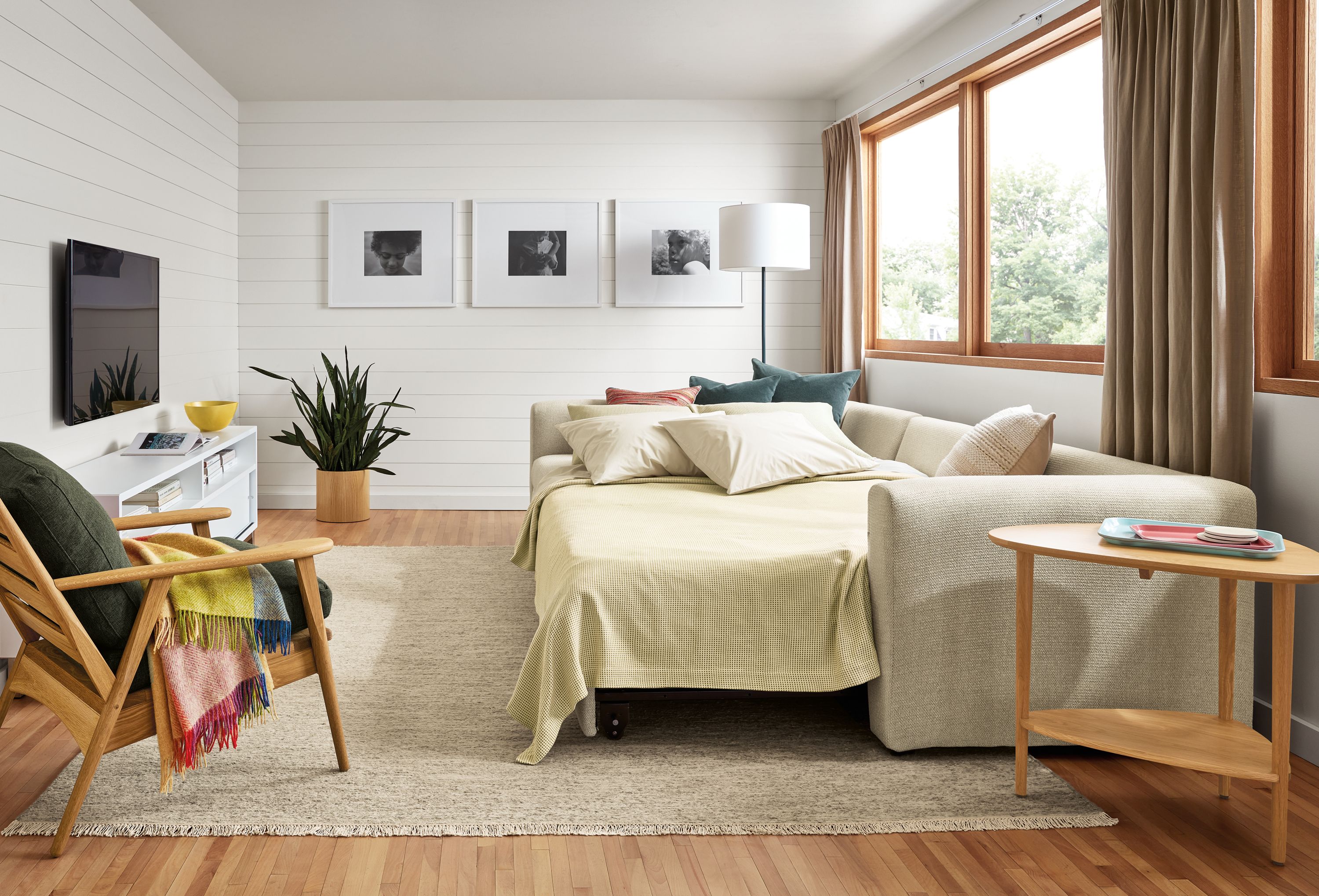 living room with oxford sleeper sofa in orla fabric with platform extended and bed made.