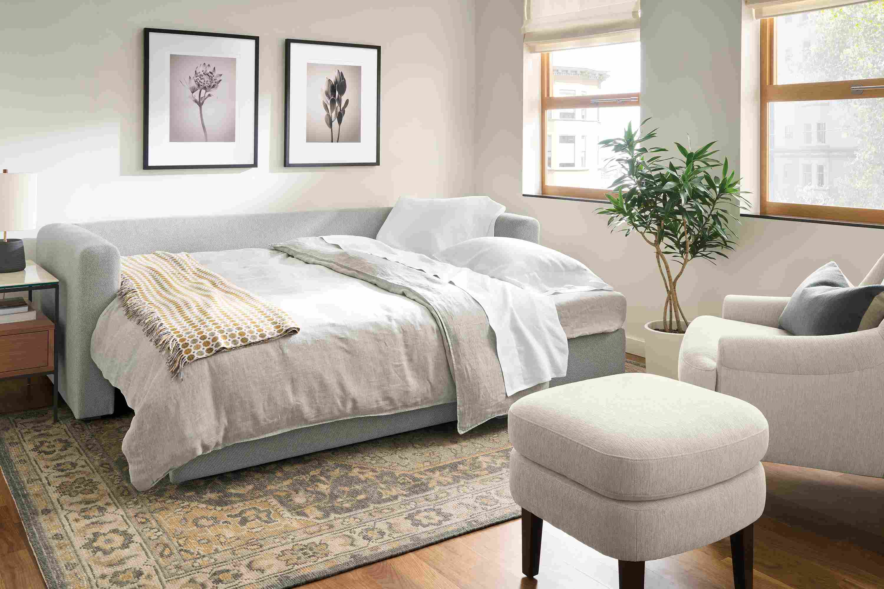 Living room with Oxford 91-wide queen sleeper in Derry Cement shown with sleeper bed fully extended.