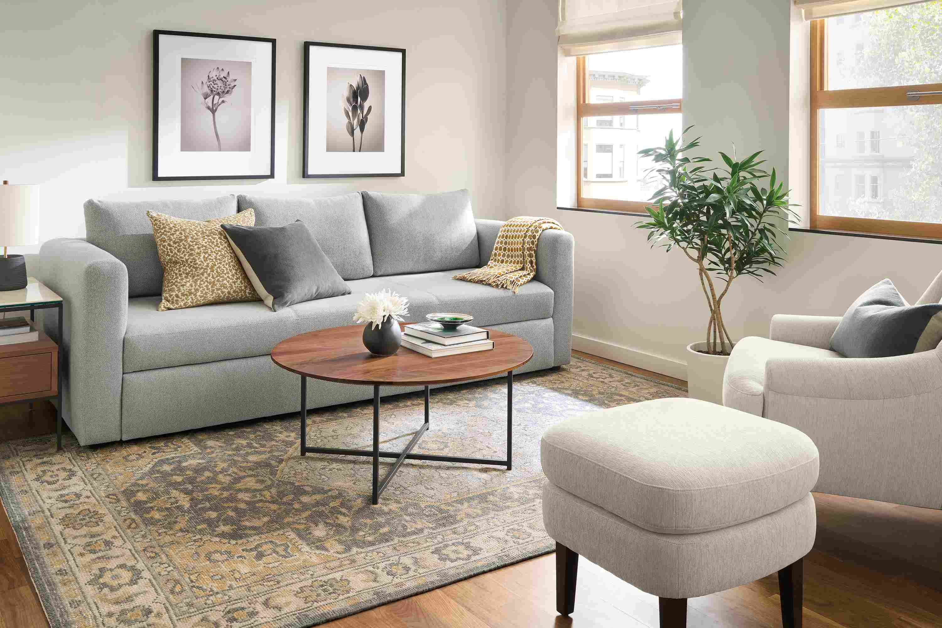 Living room with Oxford 91-wide track arm queen sleeper in Derry Cement and Veda 6 by 9 rug in smoke.