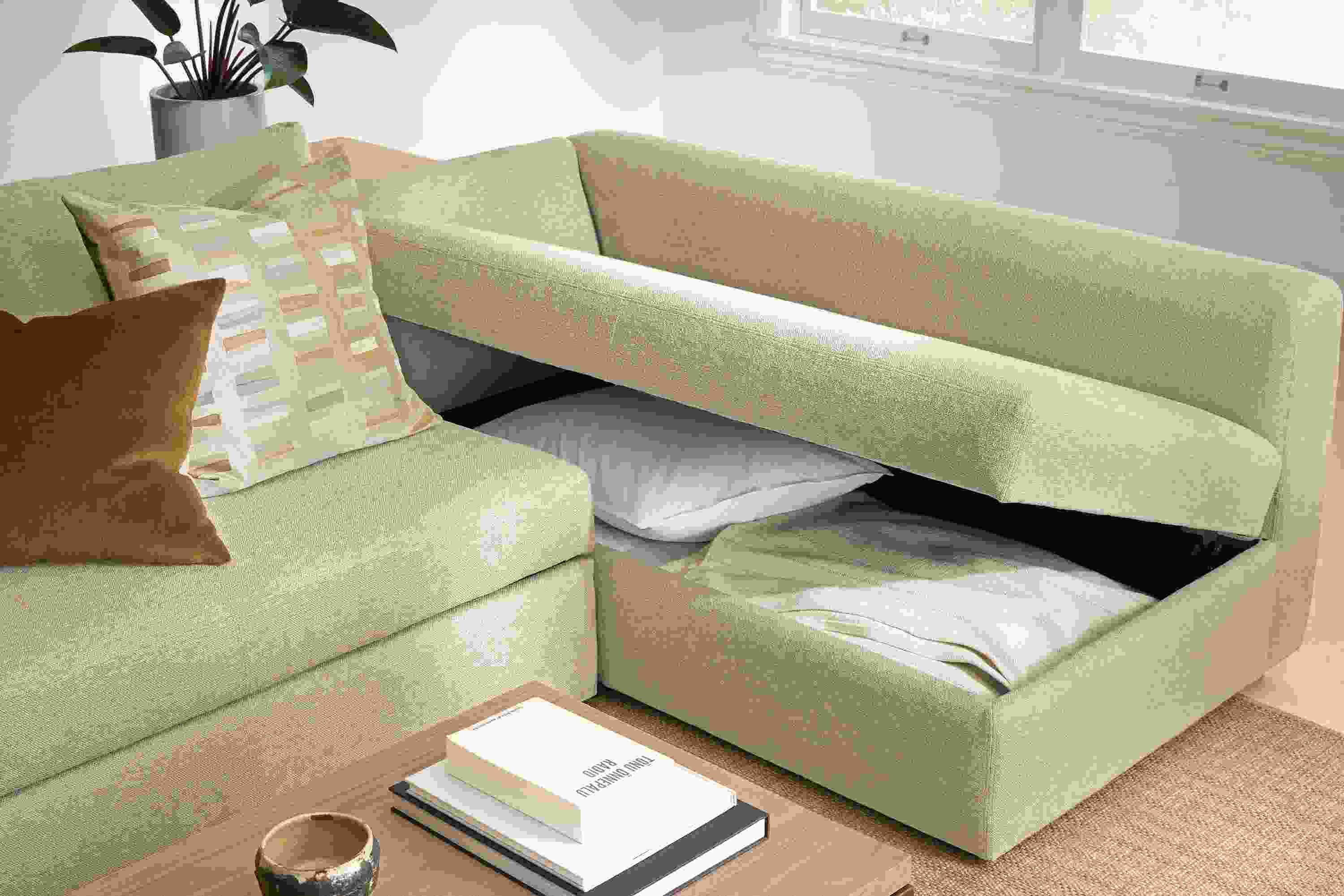 Living room with Oxford track arm 123-wide pop-up platform queen sleeper in Tatum Oatmeal showing open storage compartment.
